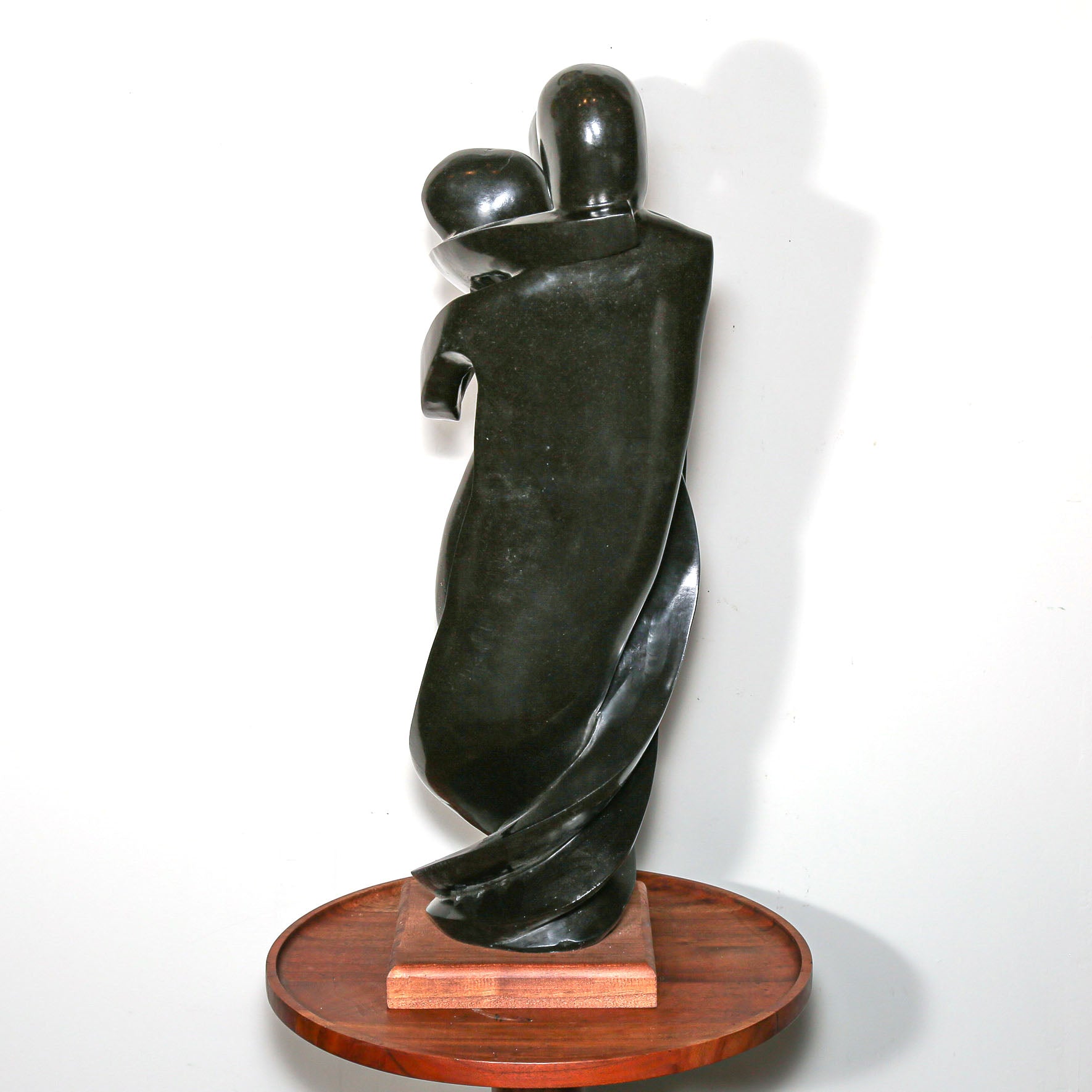 Black Sculpture of three family members hugging