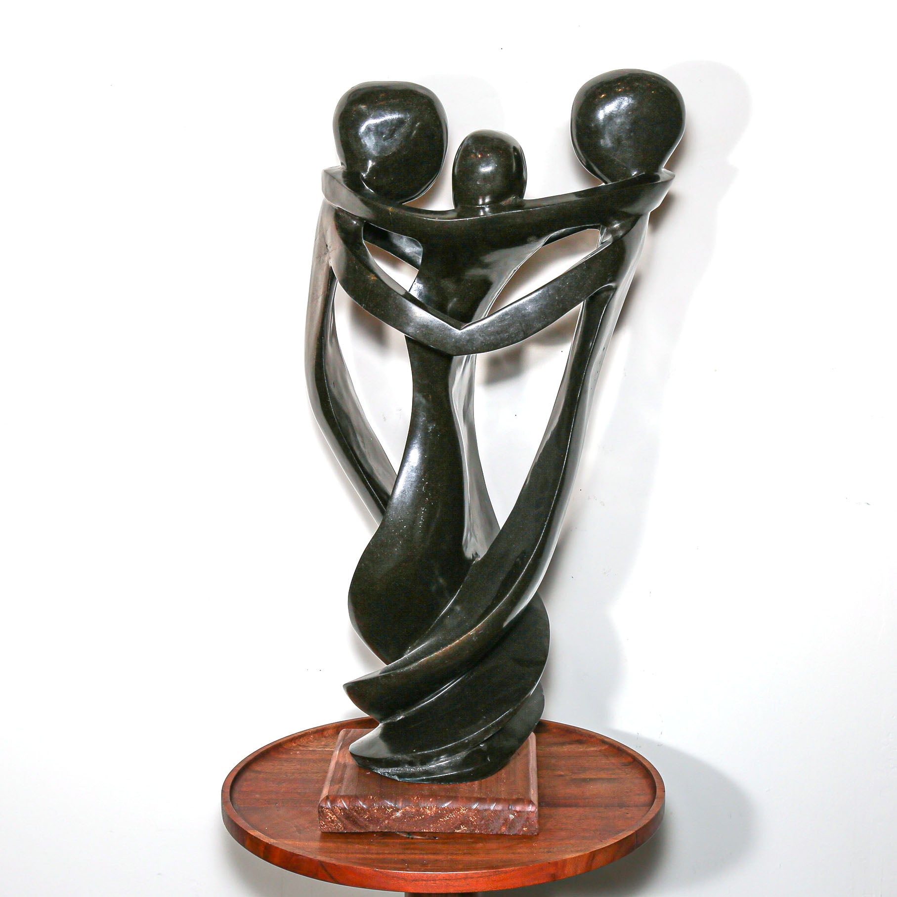 Black Sculpture of three family members hugging