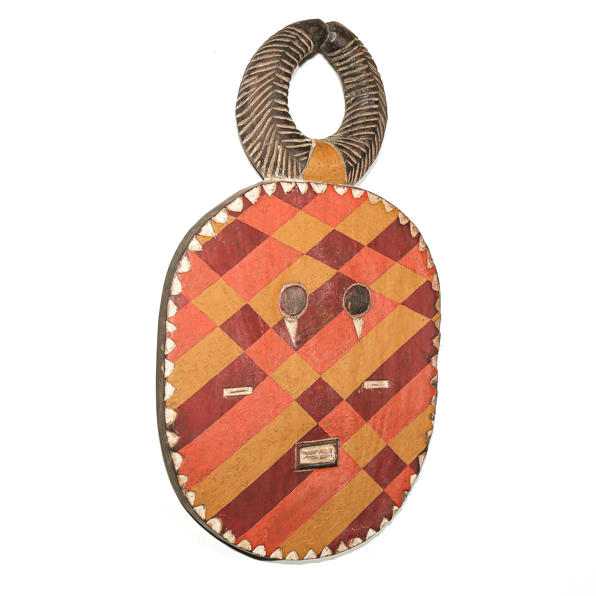 A handcrafted African wooden mask with a geometric diamond pattern in red, orange, and brown, featuring a carved handle and small metallic accents.
