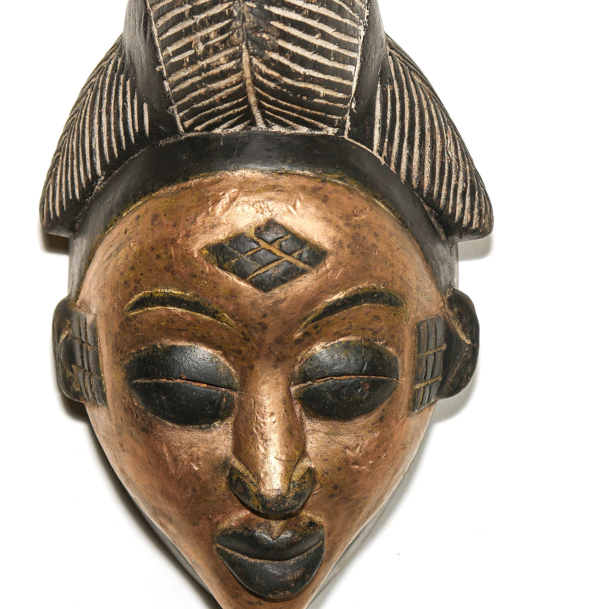 Collectible Punu mask from Gabon with gold facial paint, carved wood construction, and distinctive decorative character