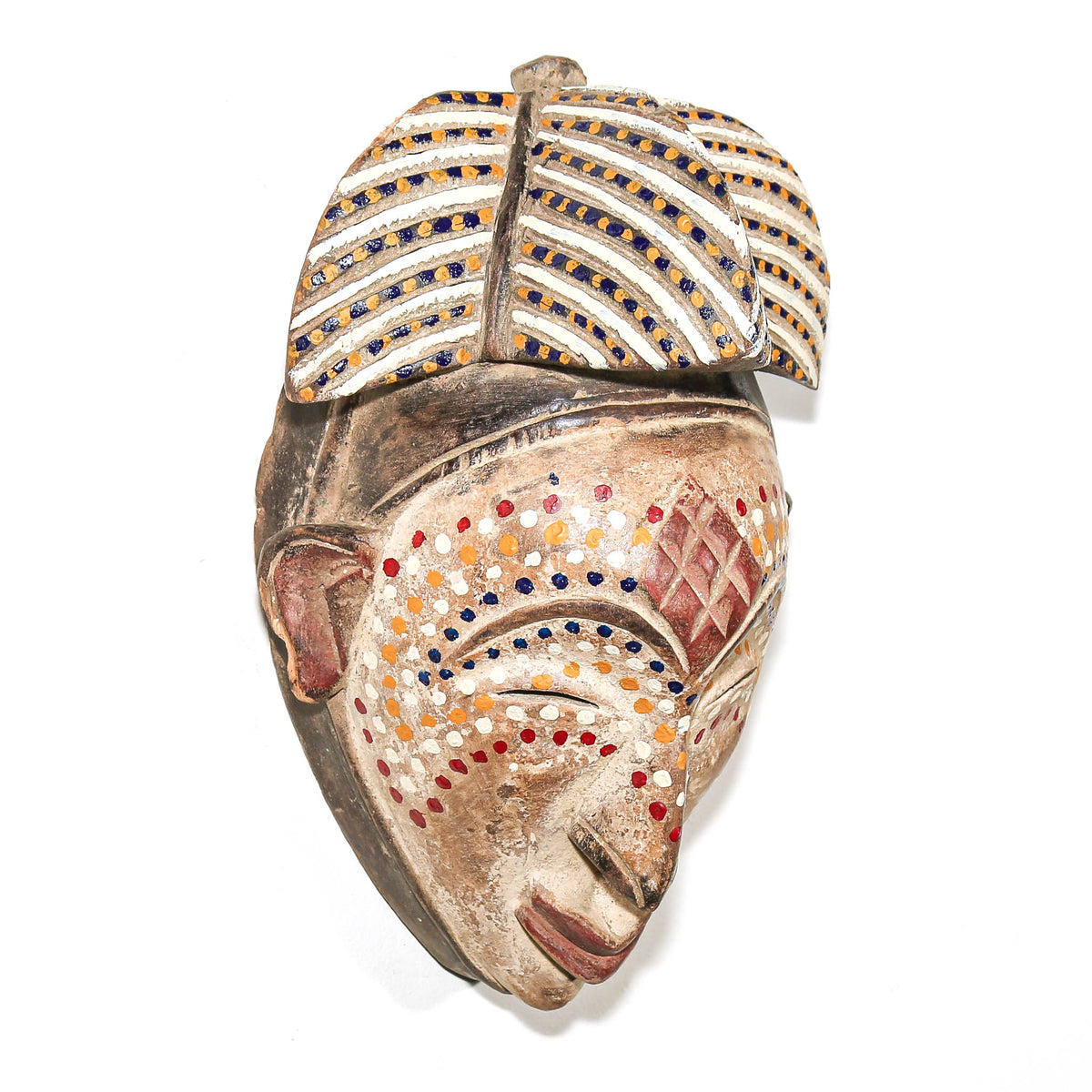 Gabonese Punu mask with distinctive dotted surface design, sculptural carved form, and classic regional character