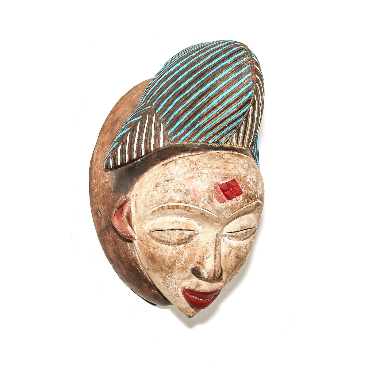 Hand-carved Punu face mask from Central Africa with colorful blue and red highlights and distinctive regional styling