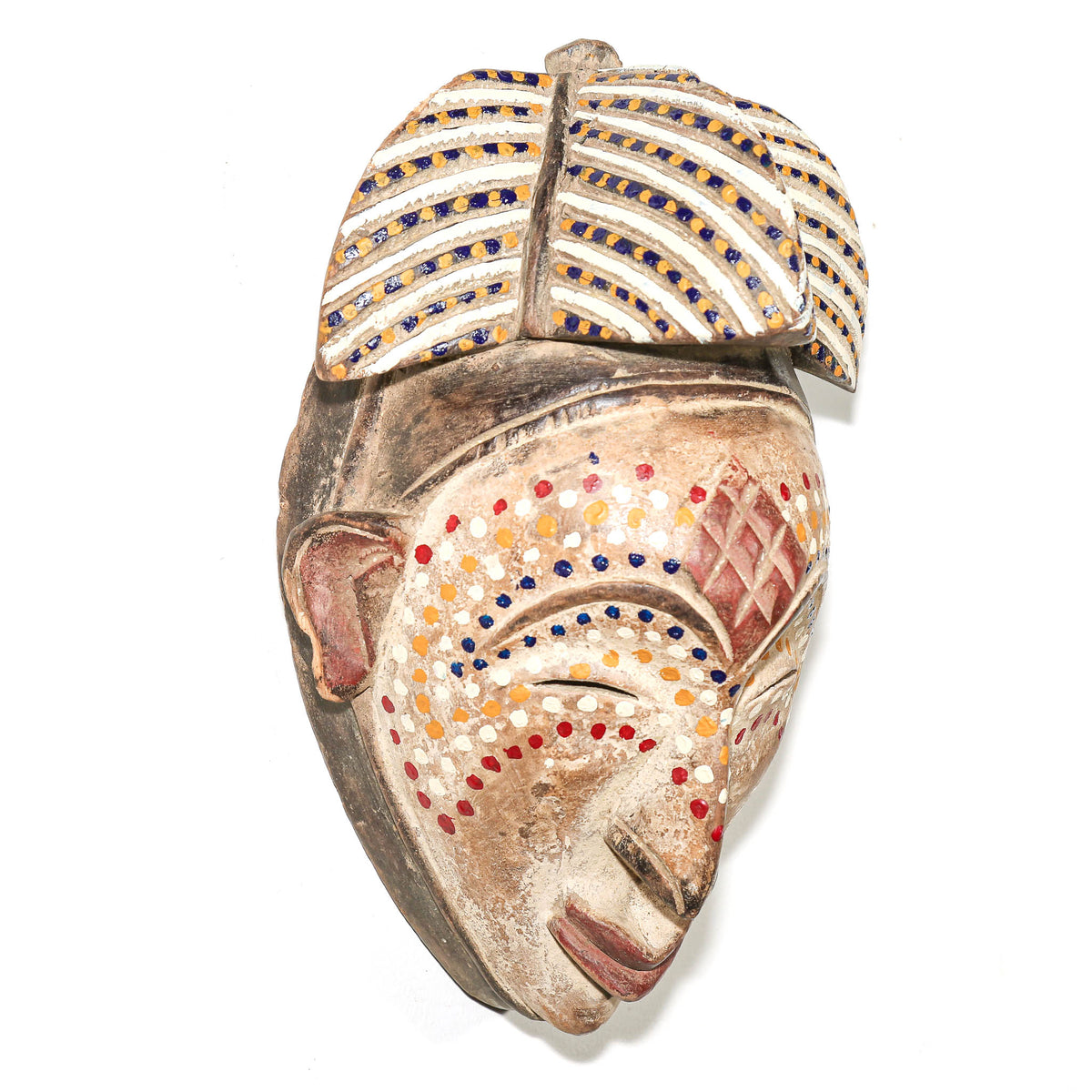 Unique dotted Punu mask from Gabon with refined carved facial features and decorative surface patterning