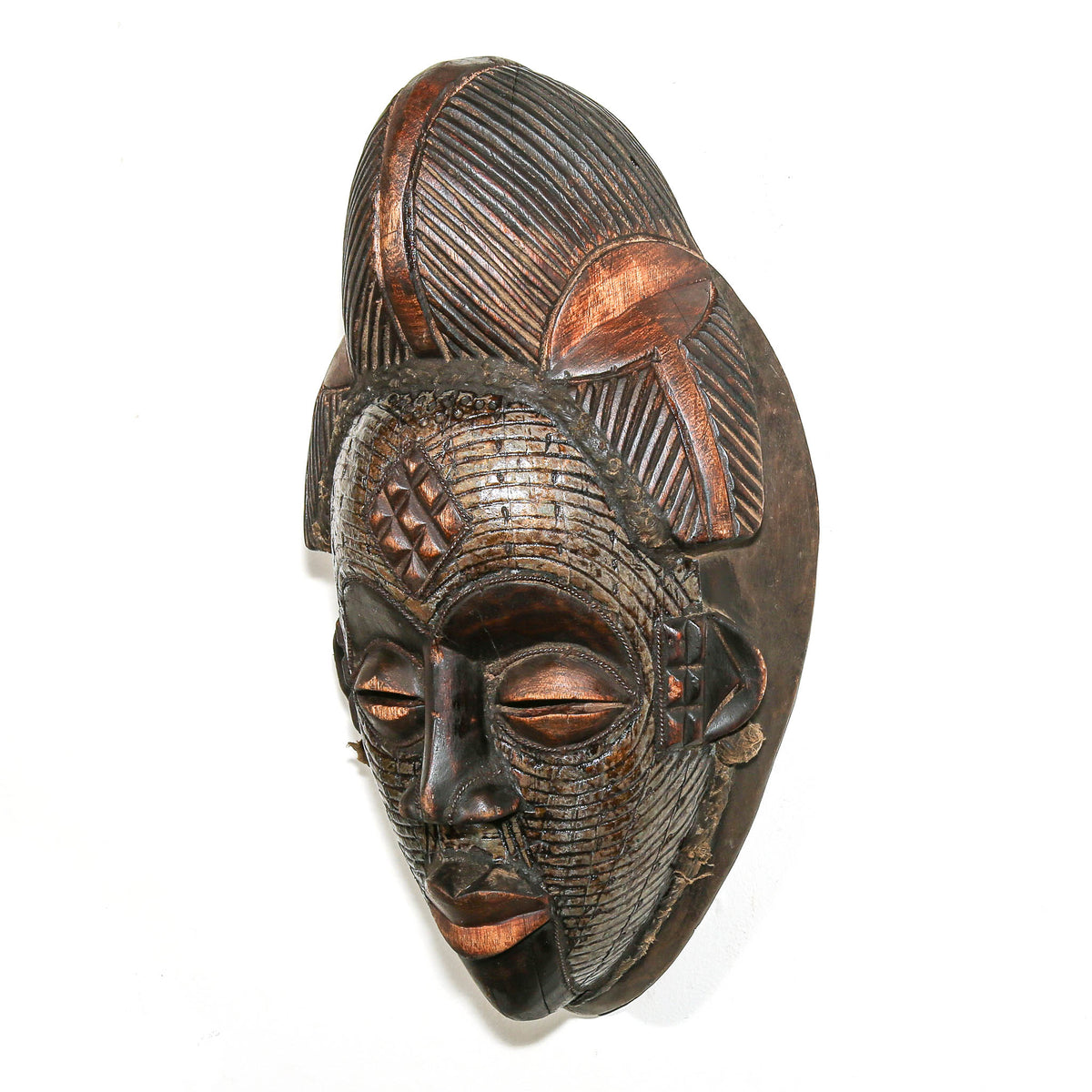 Hand-carved Gabonese Punu face mask featuring metal accents, elegant proportions, and traditional Central African styling