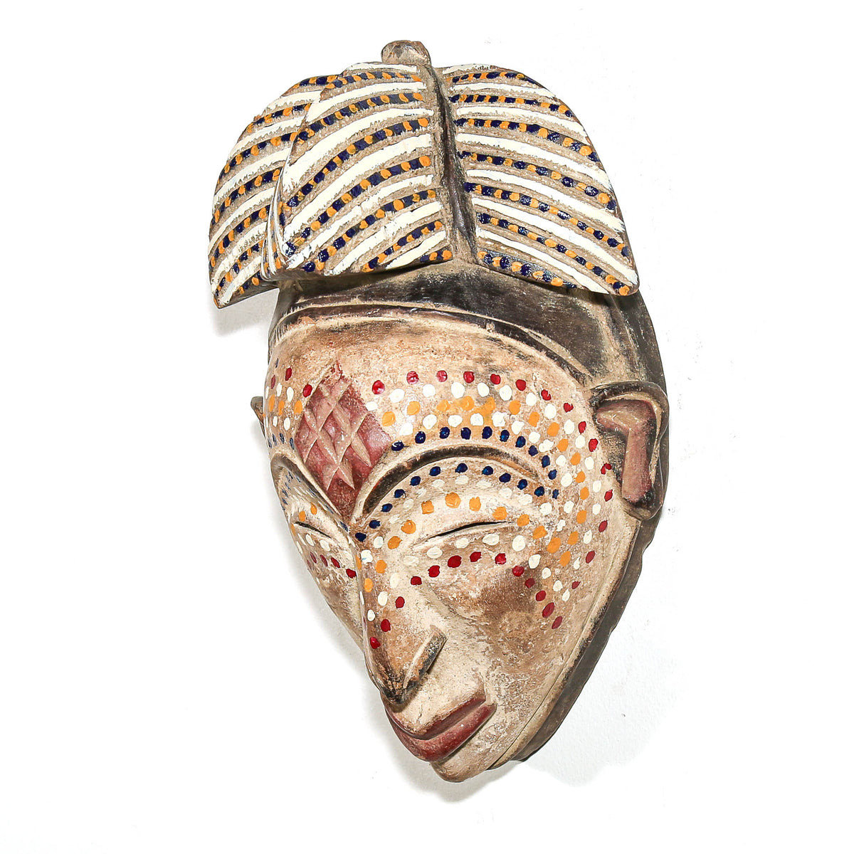 Hand-carved Punu mask with dotted details and graceful facial styling, displayed as collectible Central African tribal art