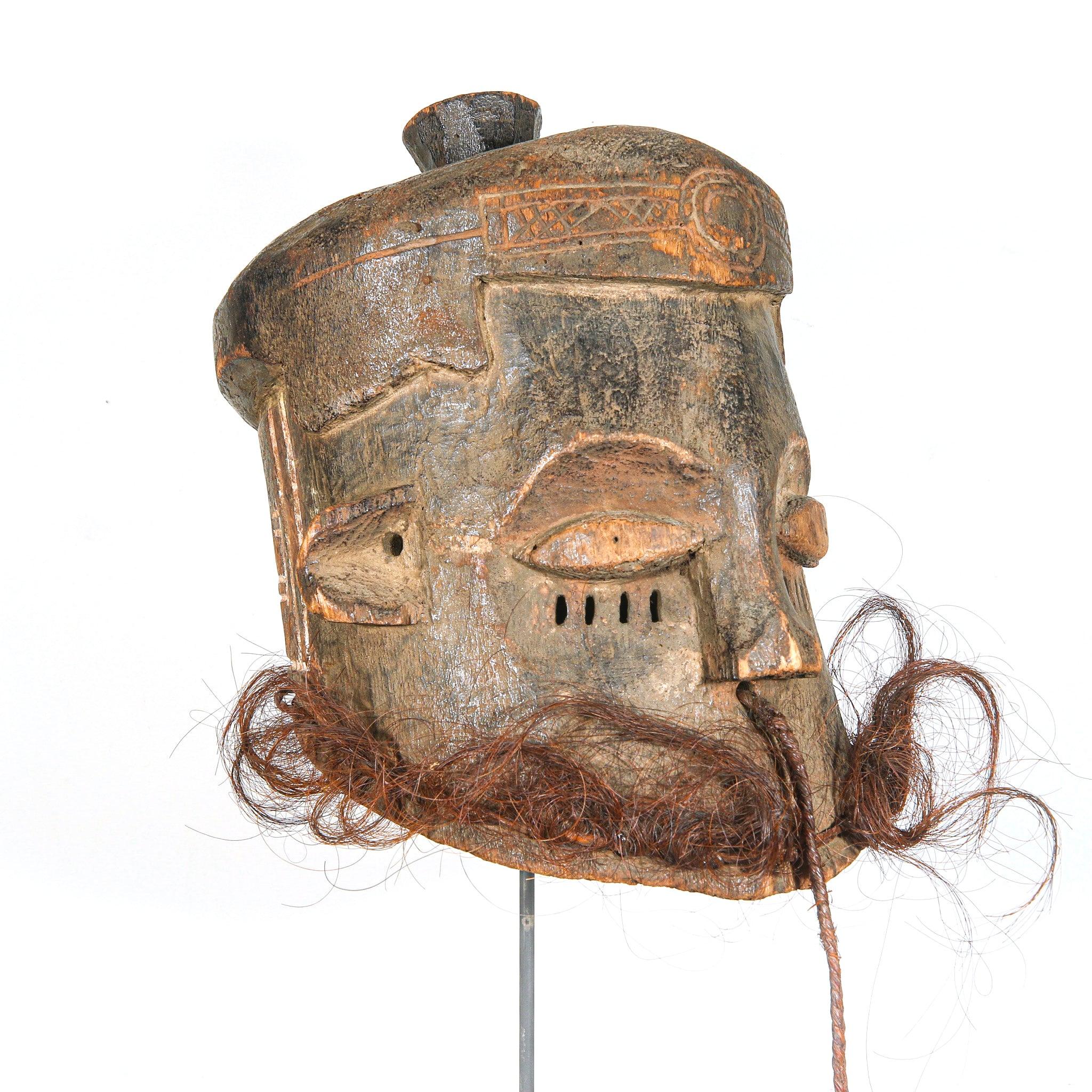 Kuba Binji Helmet Mask from D.R. Congo on a stand acting as a home decoration