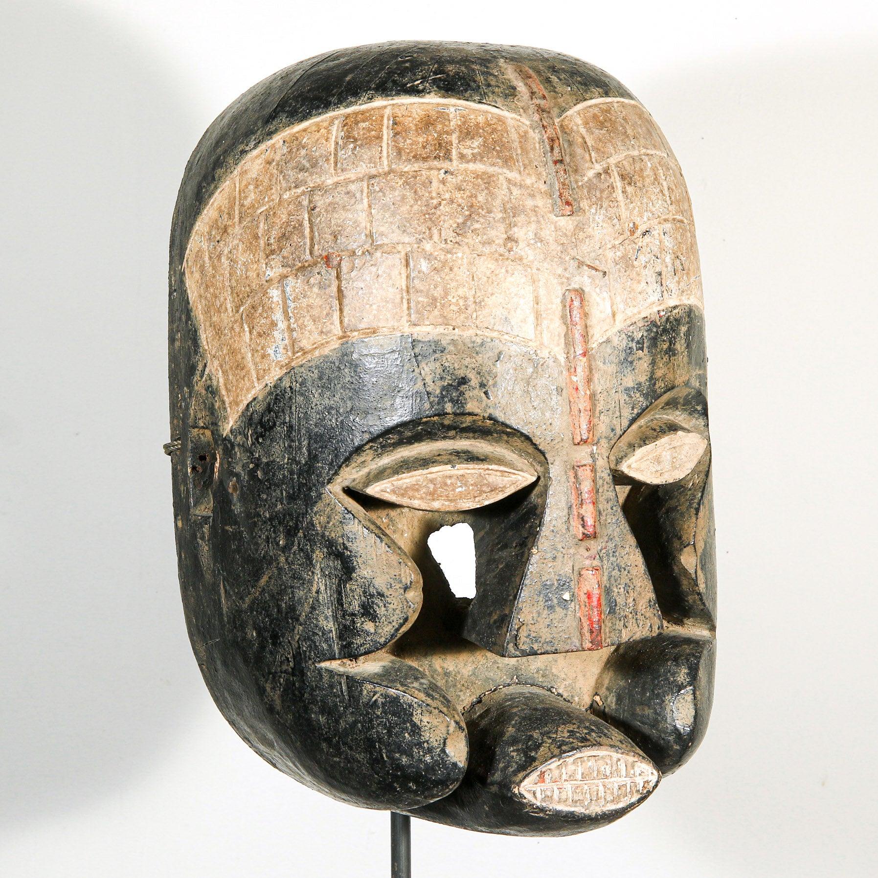 Bozo Puppet Mask from Mali on a stand as a home decor idea skewed to the left