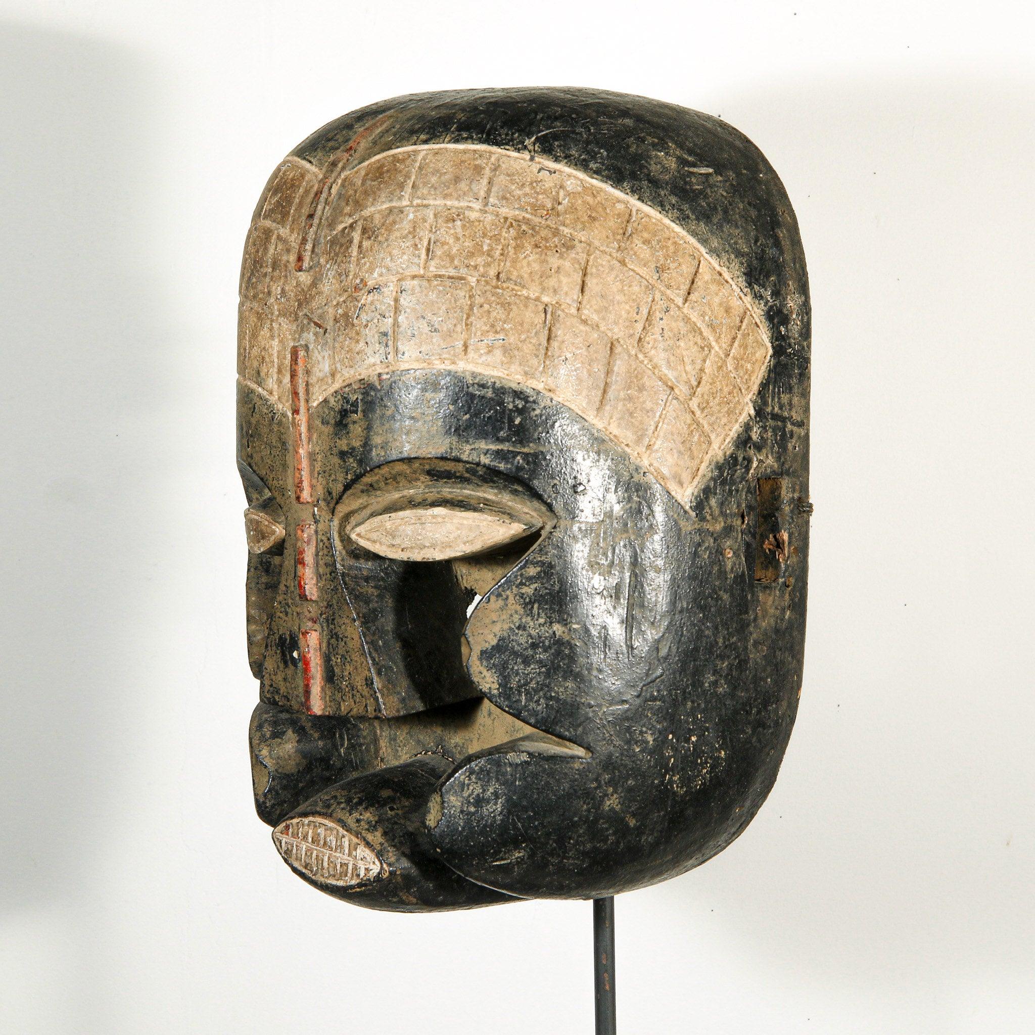 Bozo Puppet Mask from Mali on a stand as a home decor idea skewed to the right