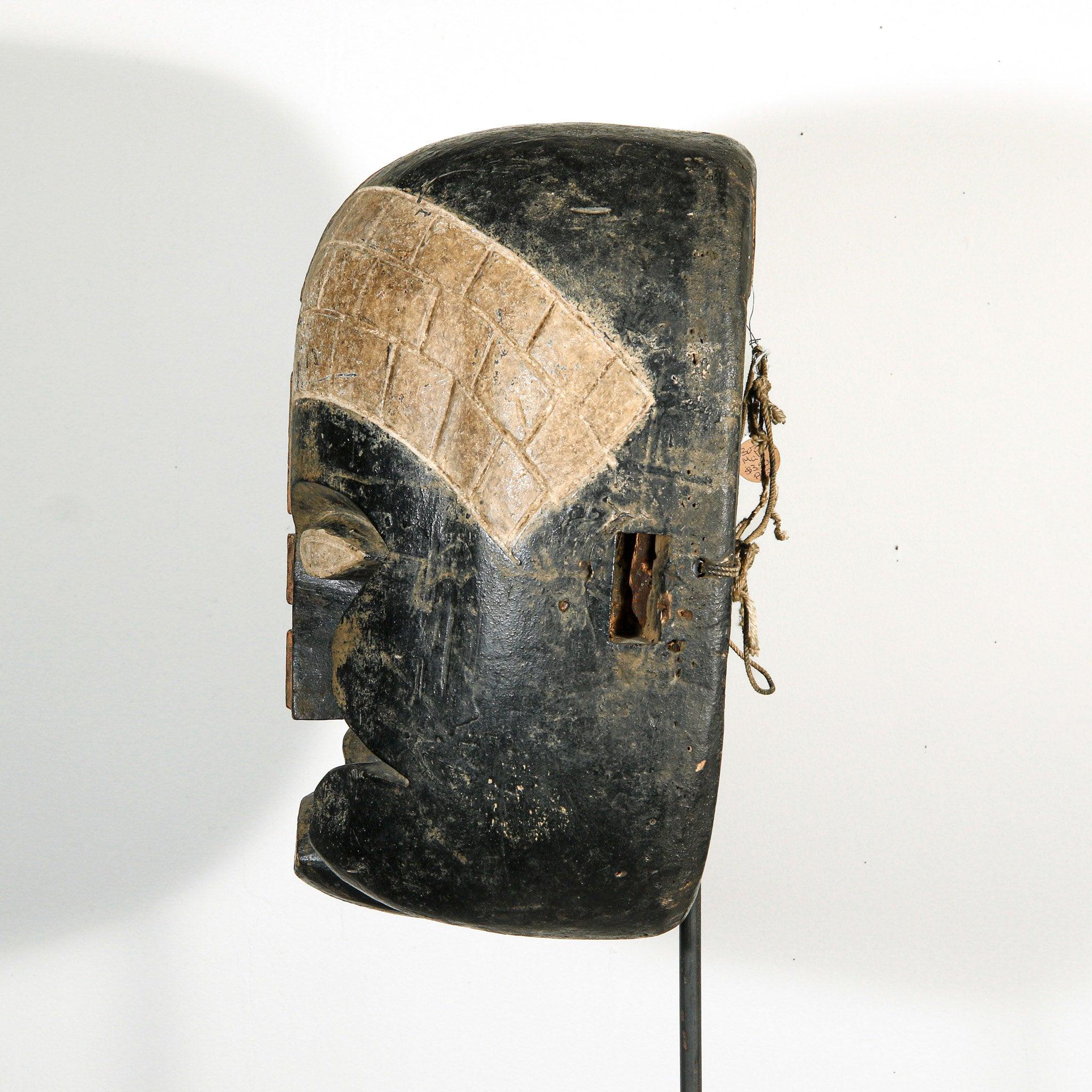 Bozo Puppet Mask from Mali on a stand as a home decor idea showing left side