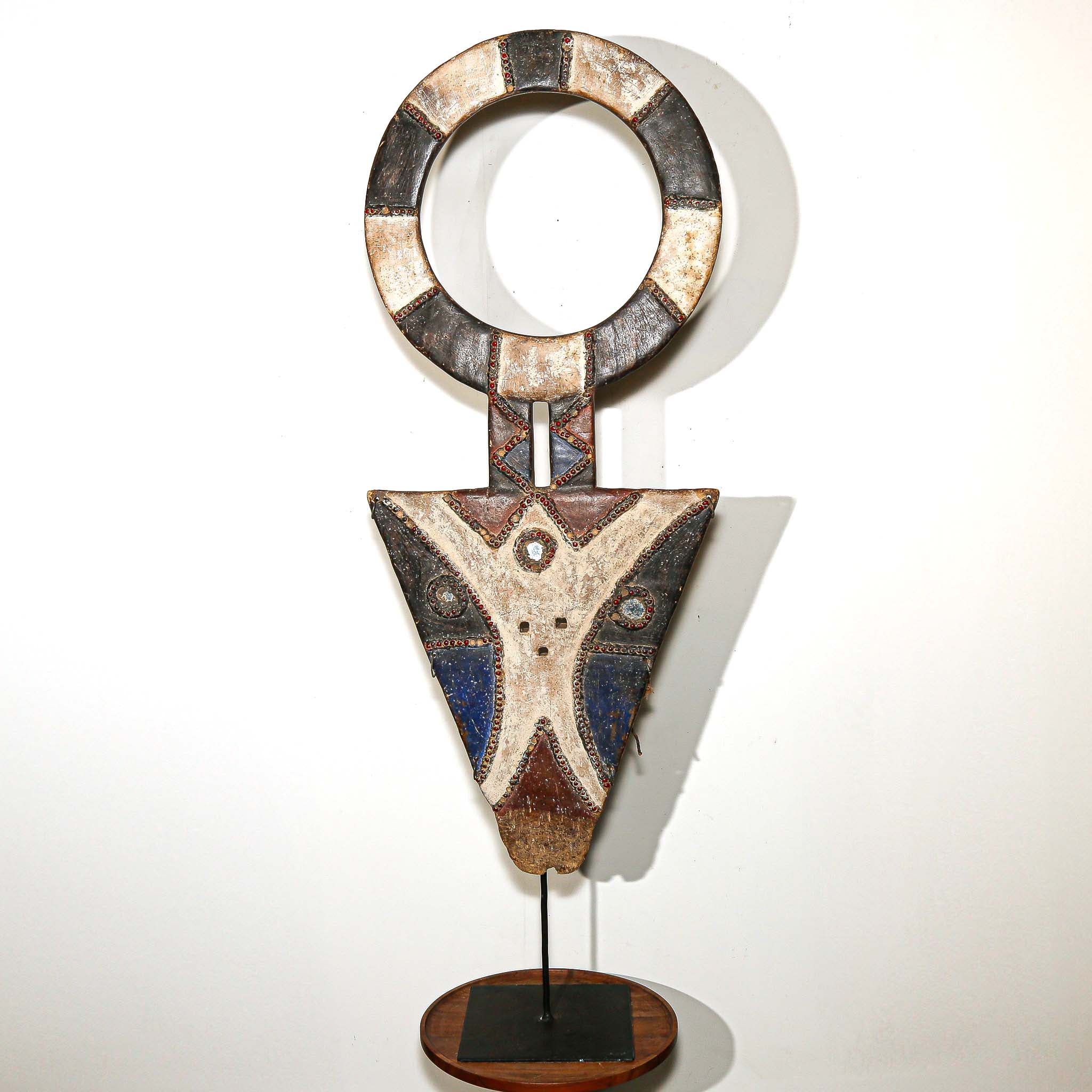 Bedu Plank Mask from Ivory Coast on a side table with display base
