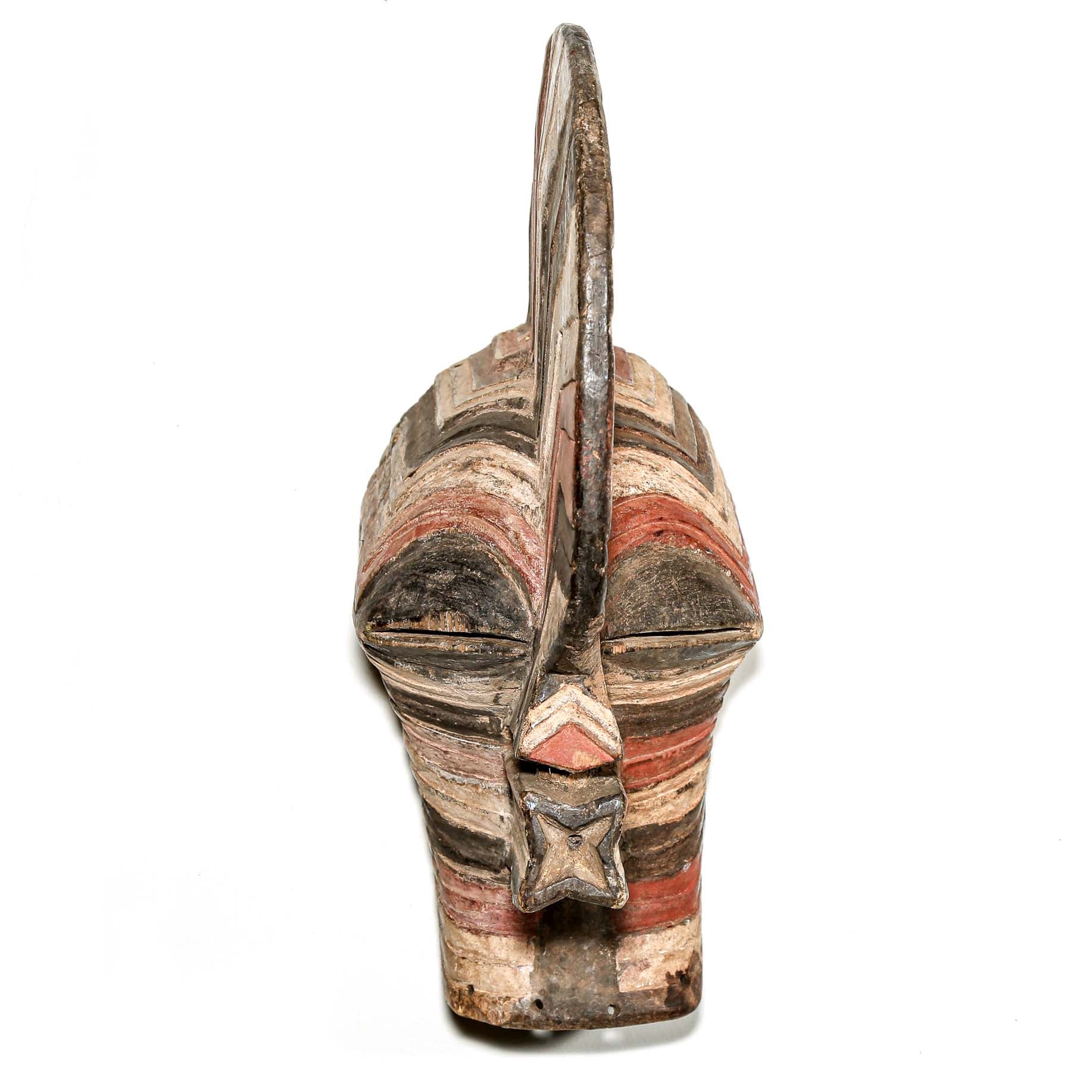 colorful Wooden African mask with striped pattern hanging on a white wall for sale