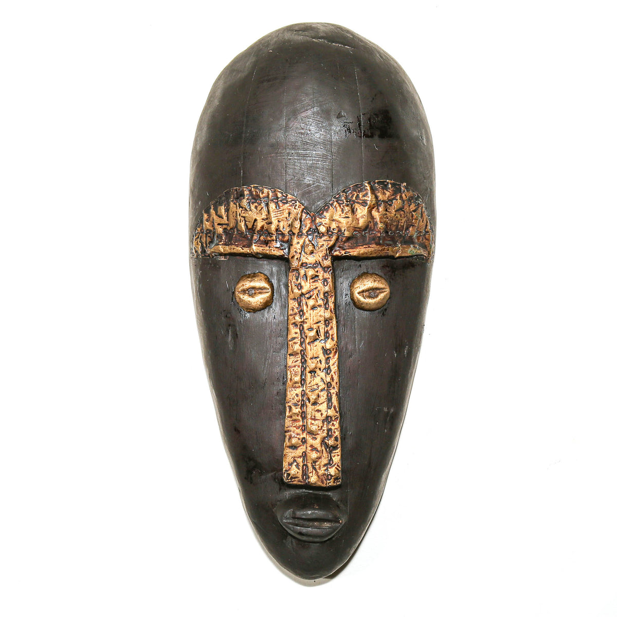 A dark carved wooden African-style mask with metallic gold-painted details on the forehead, nose, and eyes, shown against a plain white background.