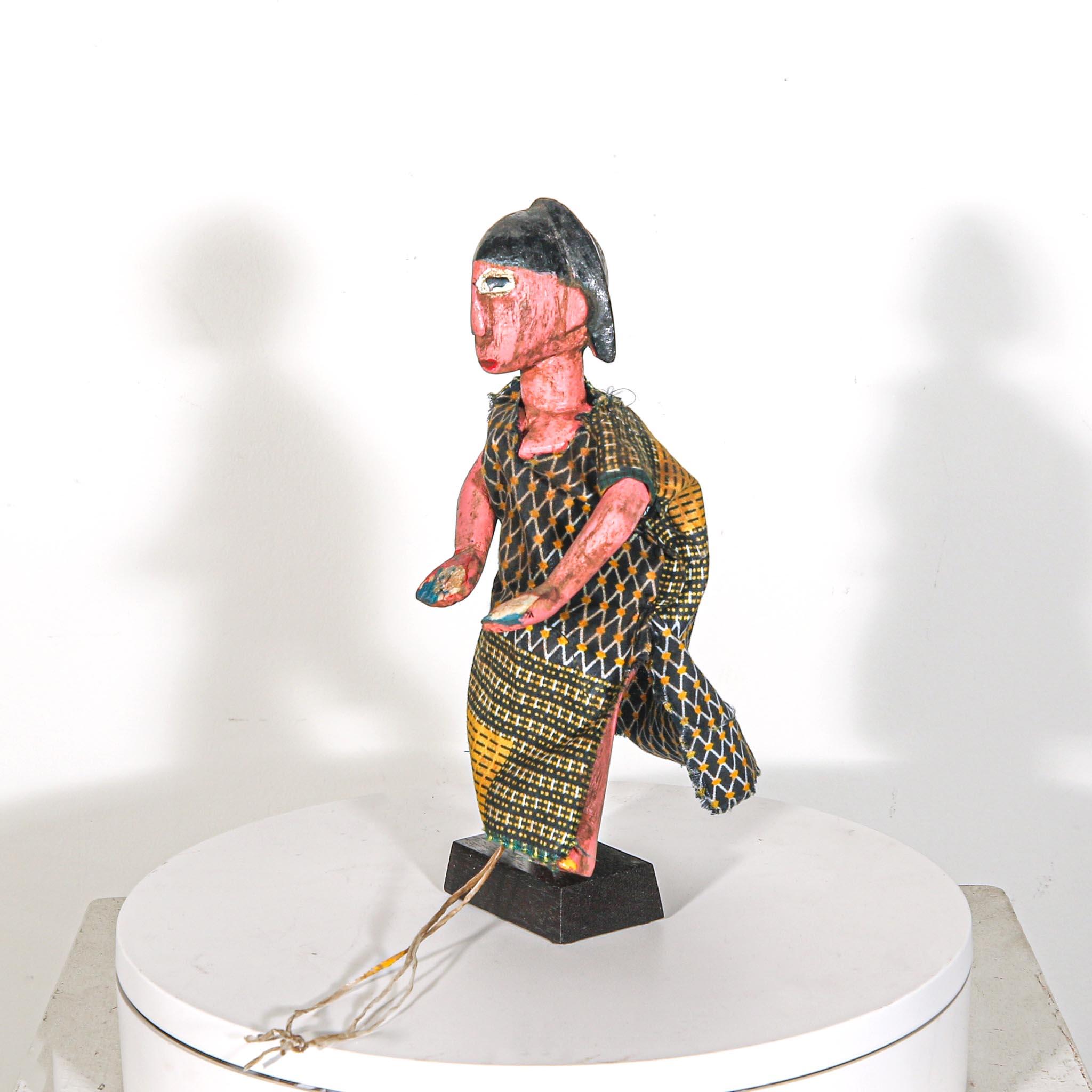 Puppet Doll from Mali standing on a display showing left side