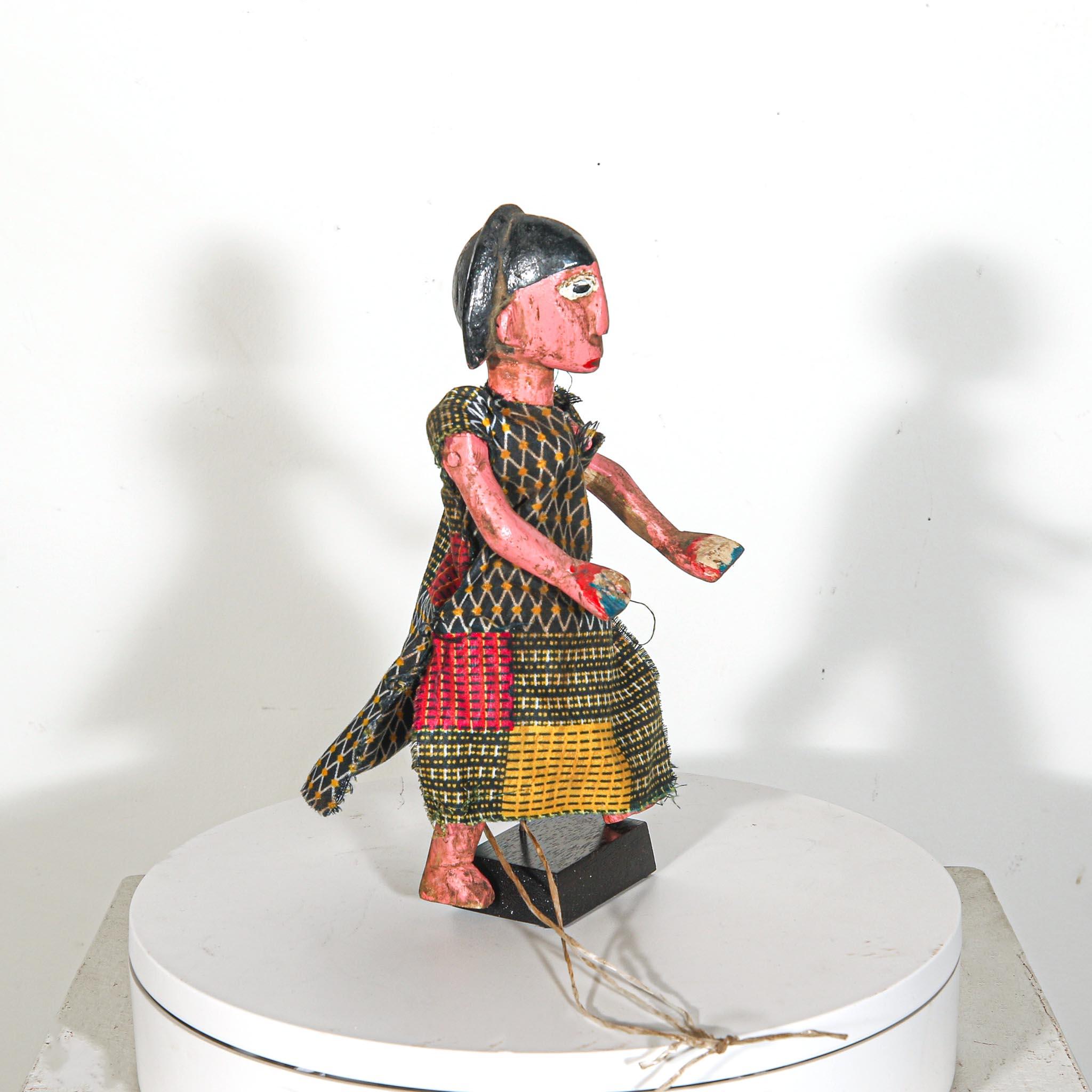 Puppet Doll from Mali standing on a display showing right side 