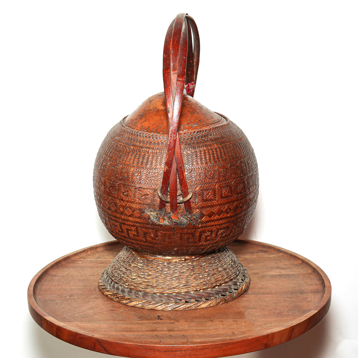 Traditional African basketry with woven plant fiber over a natural gourd form