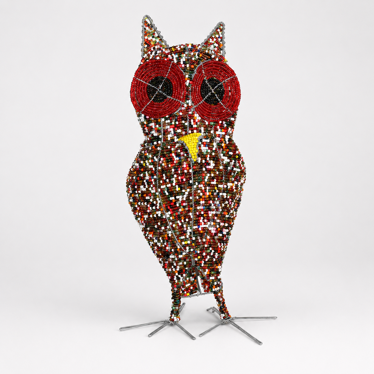 Decorative owl sculpture with multicolored pattern on a white background