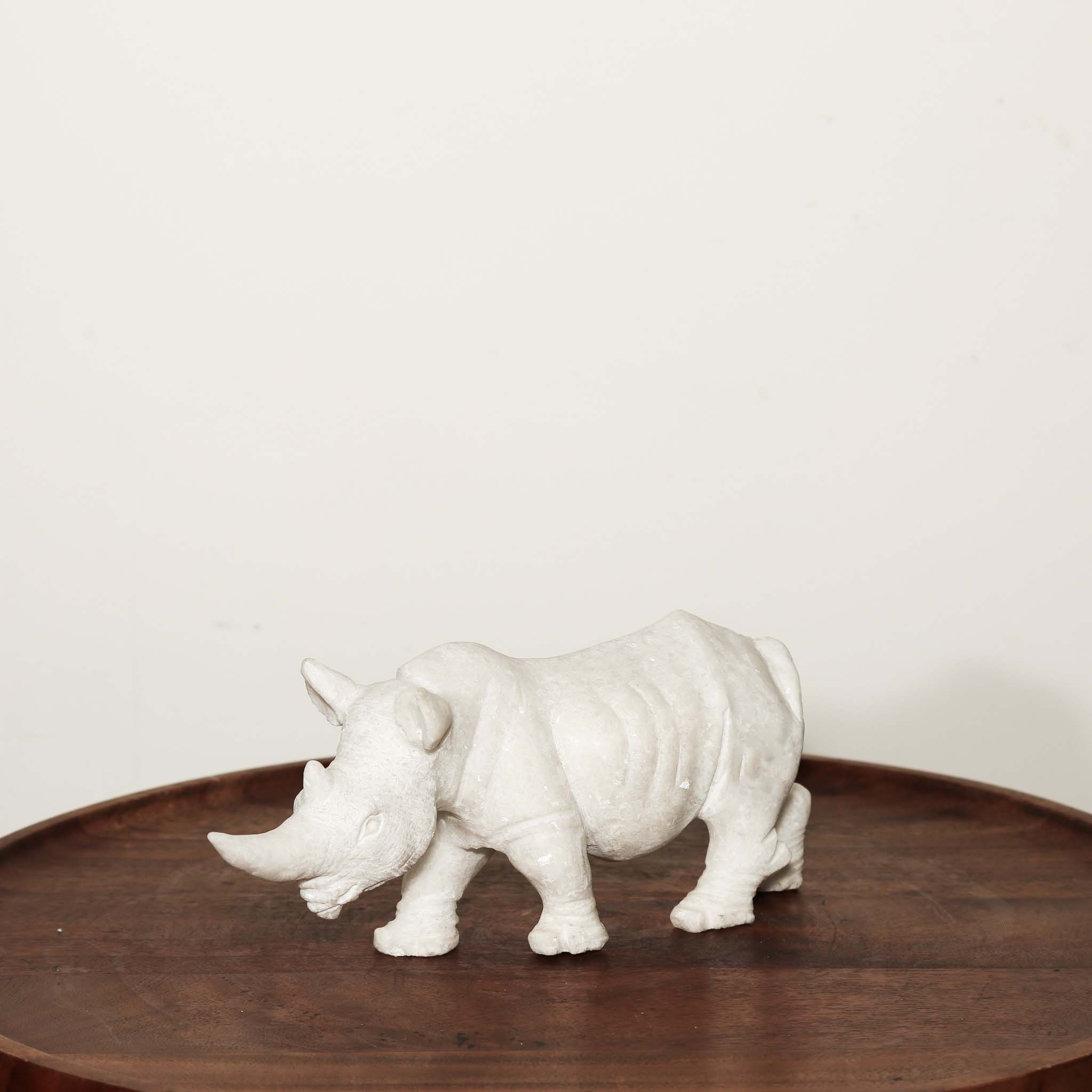 Black Rhinoceros Sculpture in White Stone on a table