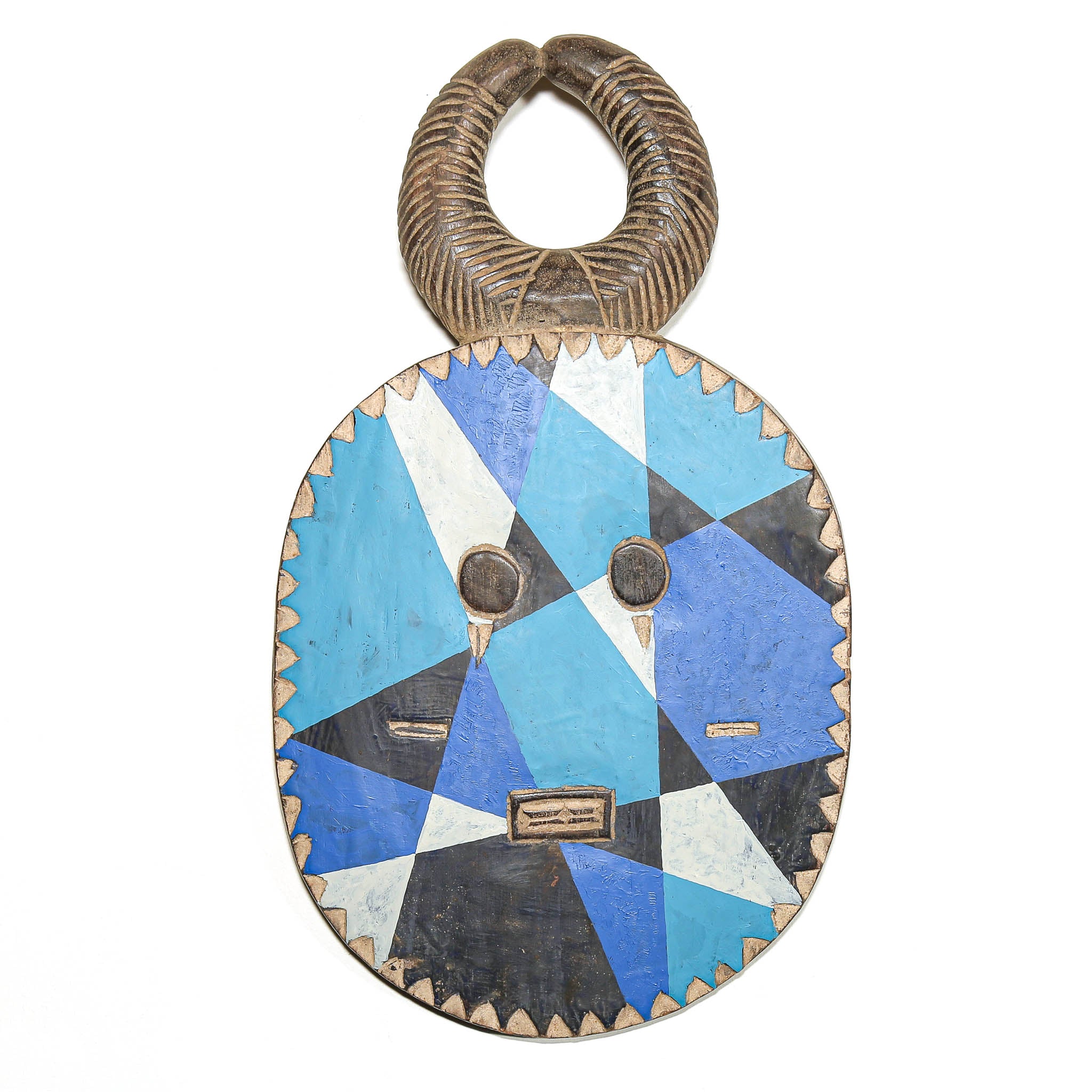 A traditional African wooden mask with a geometric blue, black, and white inlay pattern, featuring a textured brown loop handle at the top, shown against a plain white background.