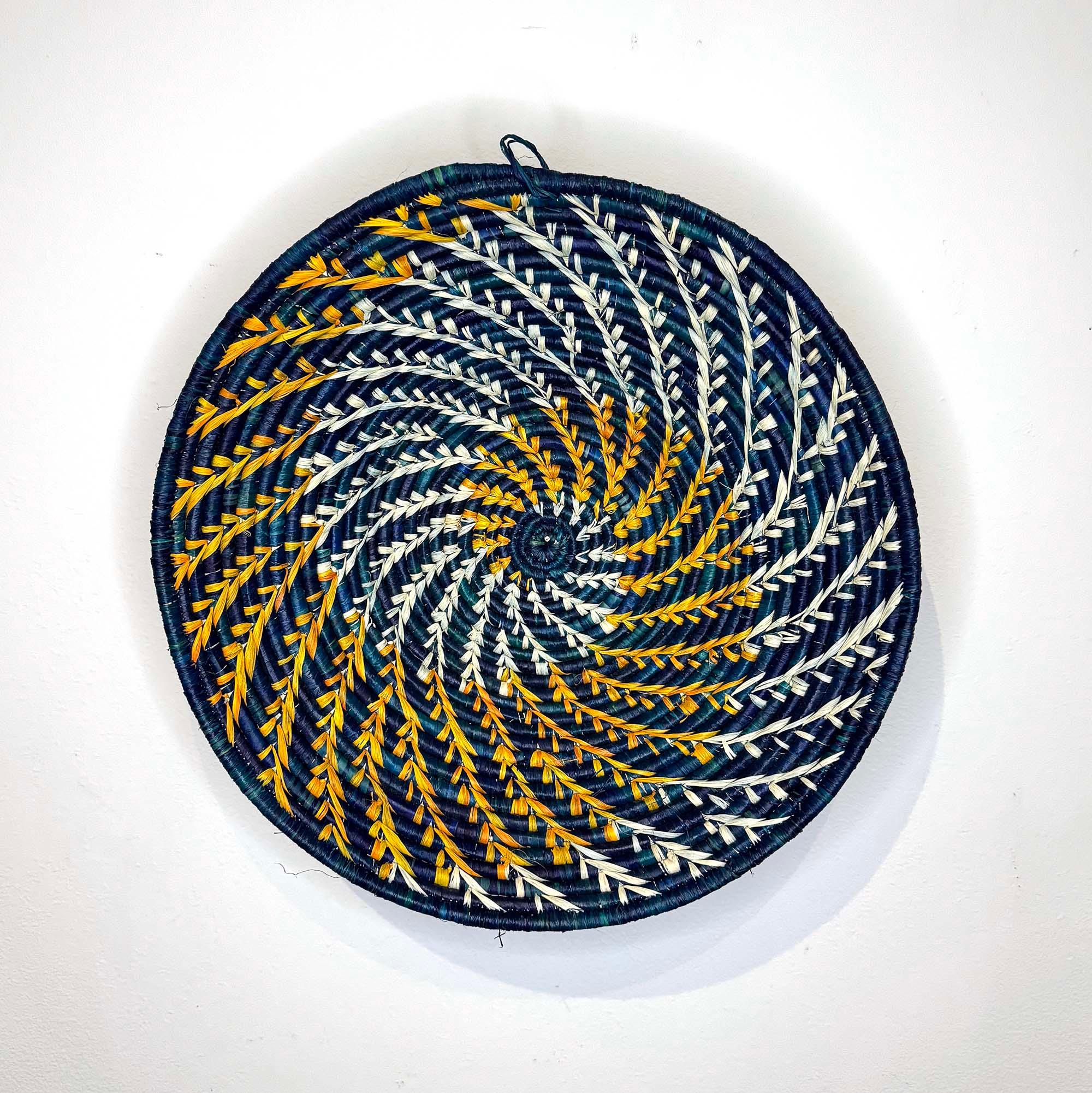 Blue Woven Basket Handmade in Uganda hanging on a wall