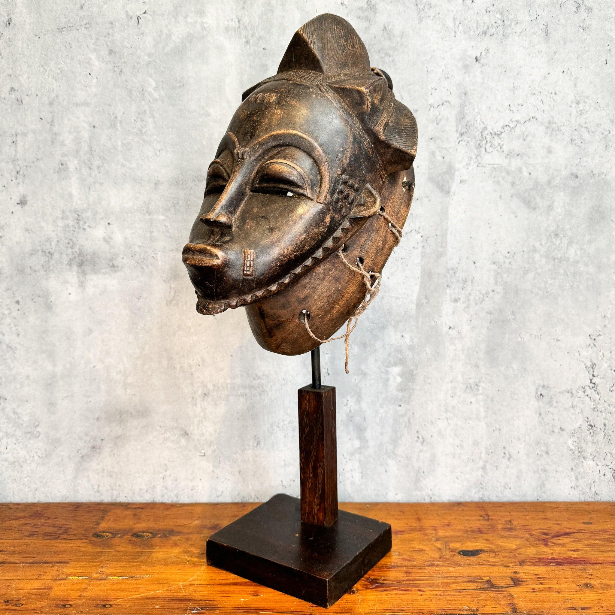 Baule Kpan Mask from Cote d'Ivoire on a stand as an African mask decoration