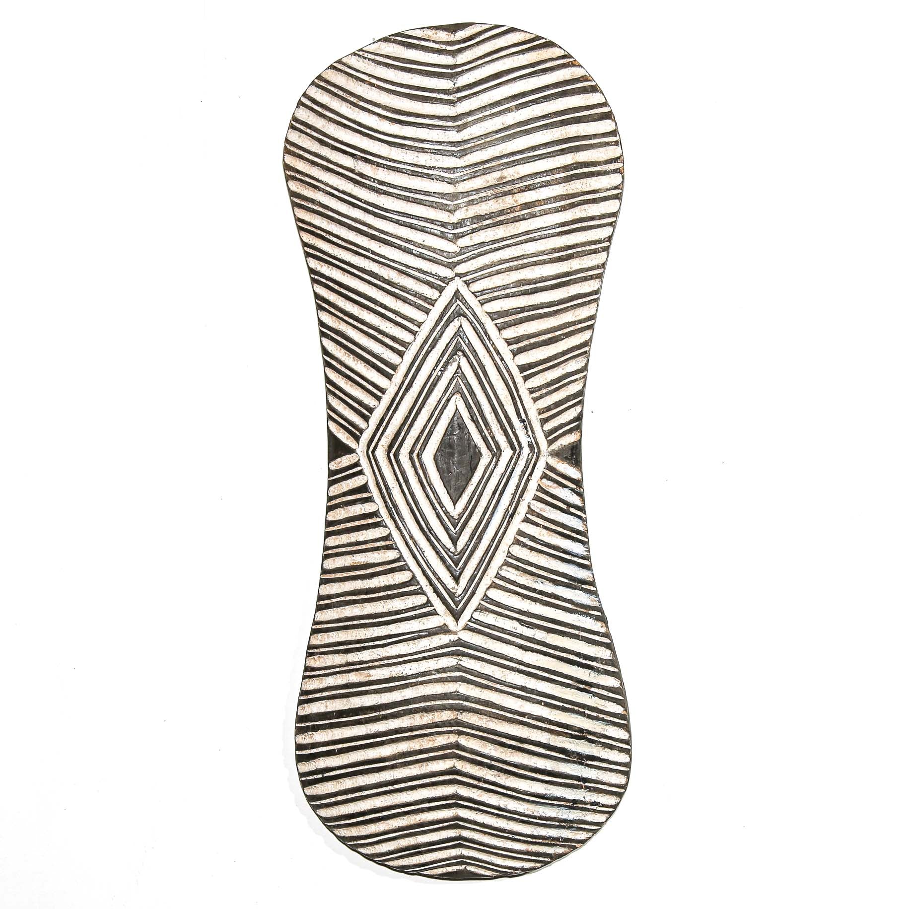 Decorative wall art from Africa with geometric pattern on a white home wall