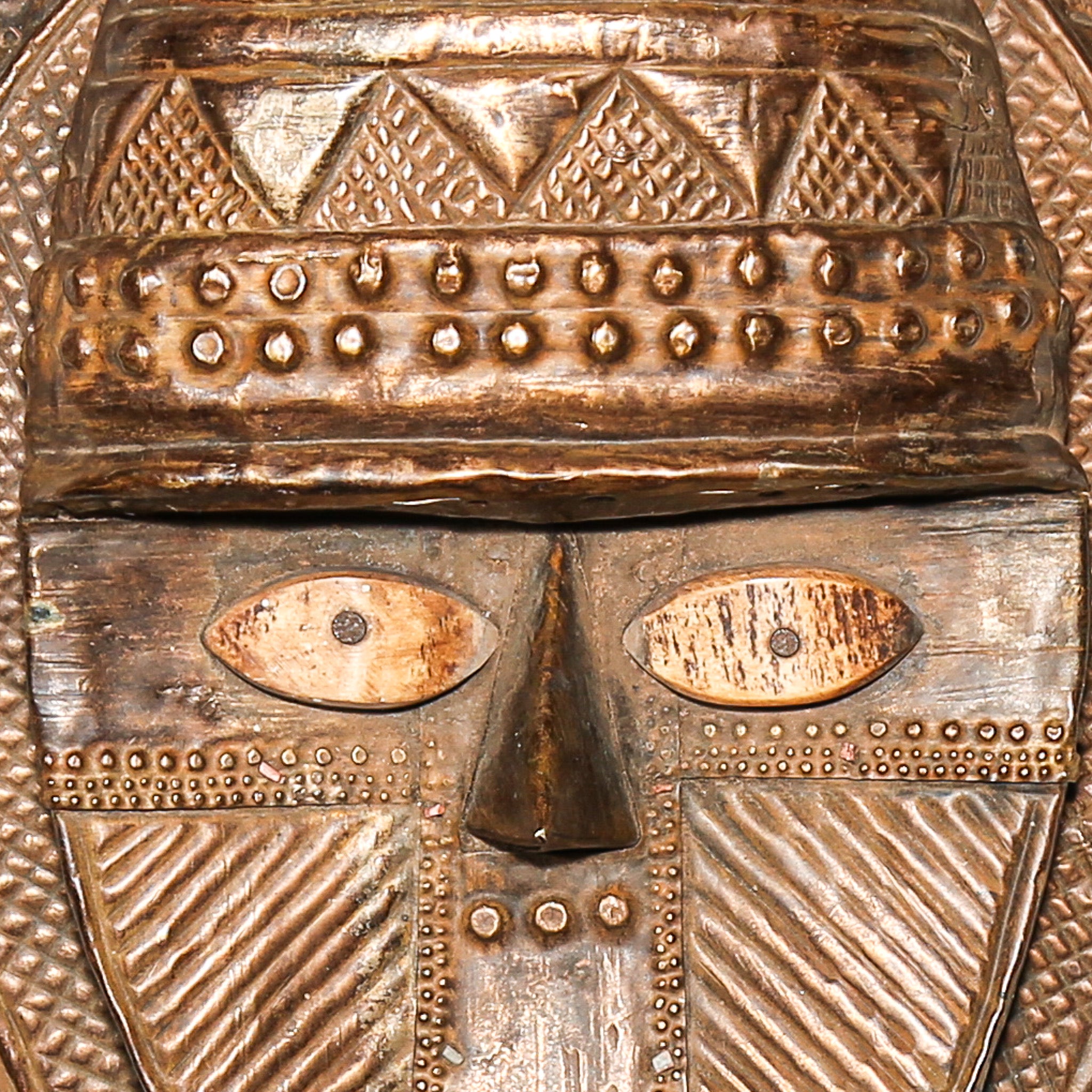 Close-up of copper and brass surface on antique Kota reliquary figure from Gabon