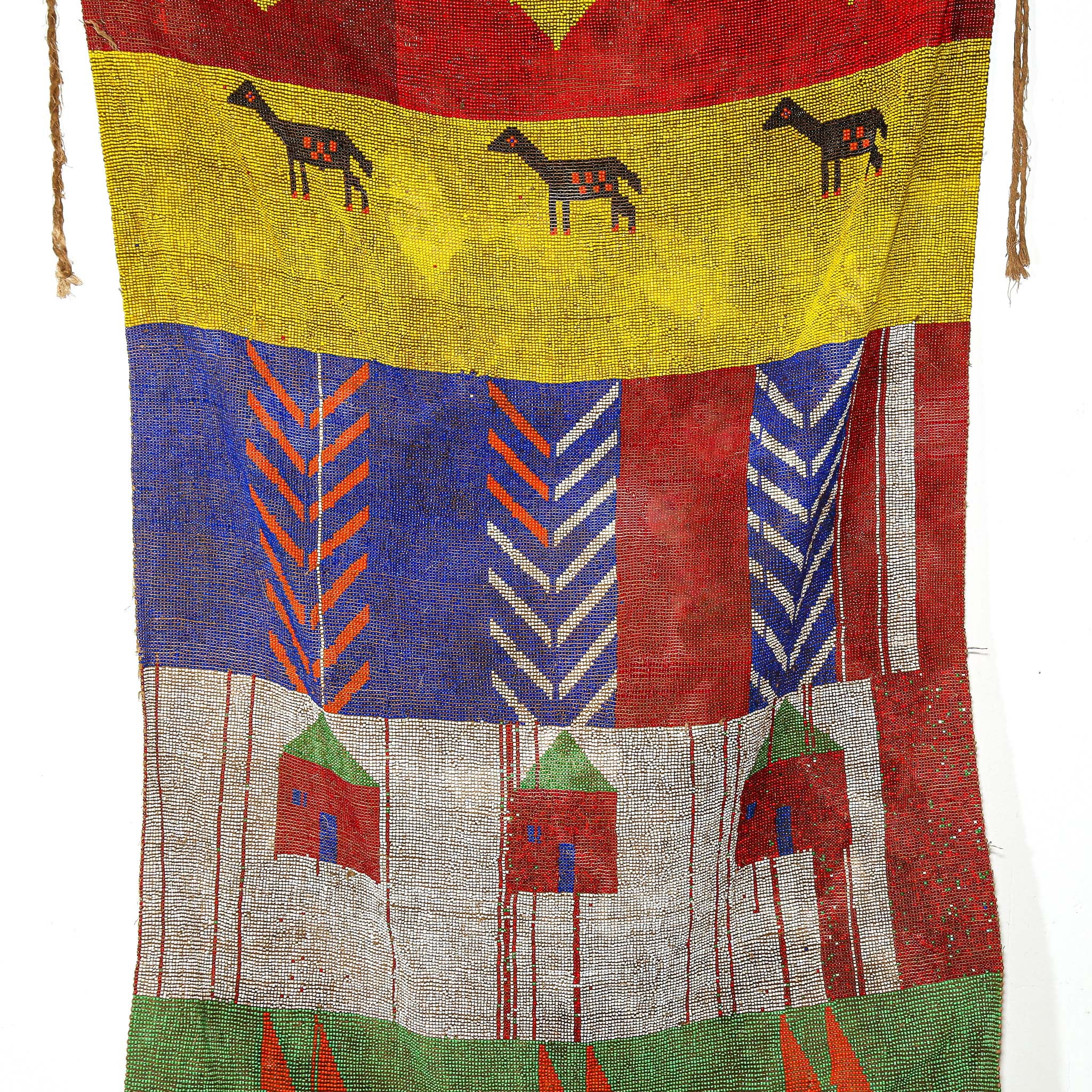 Colorful textile with geometric patterns and animal illustrations on a white background