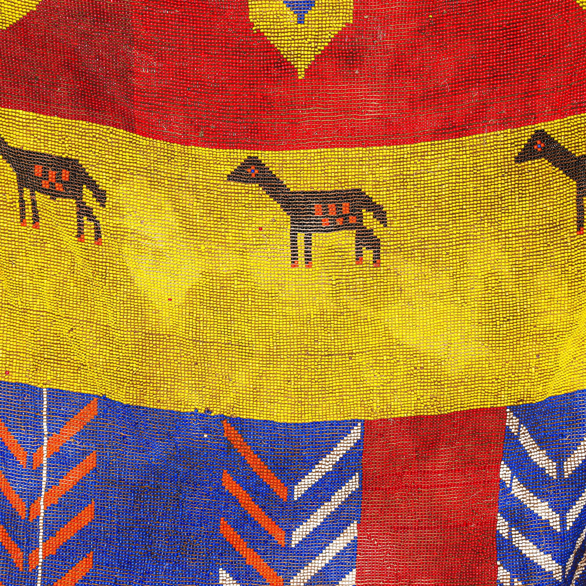 Close-up of a colorful beaded fabric with horse patterns and geometric shapes.