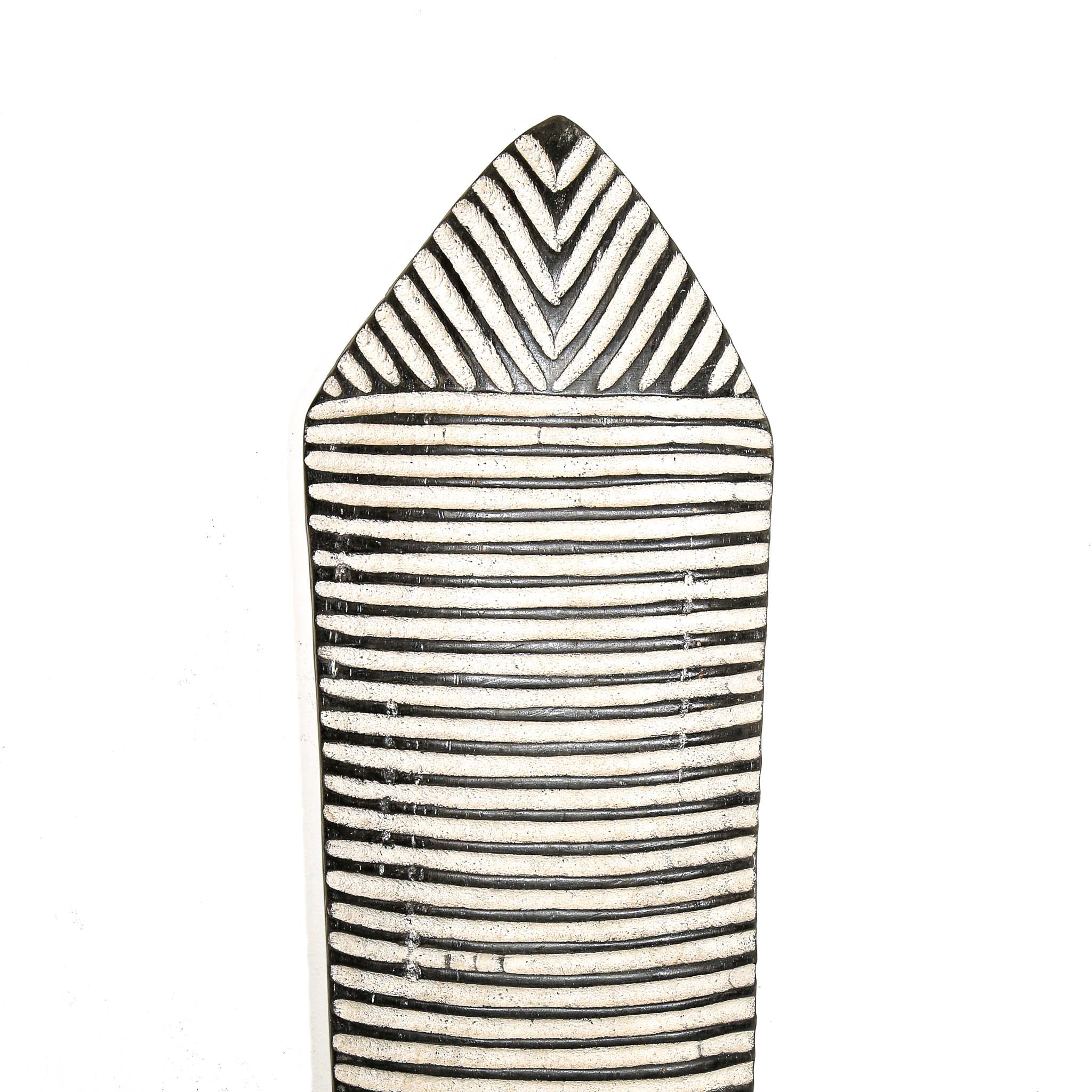 Black and white striped carved wood shield for wall design on a white background