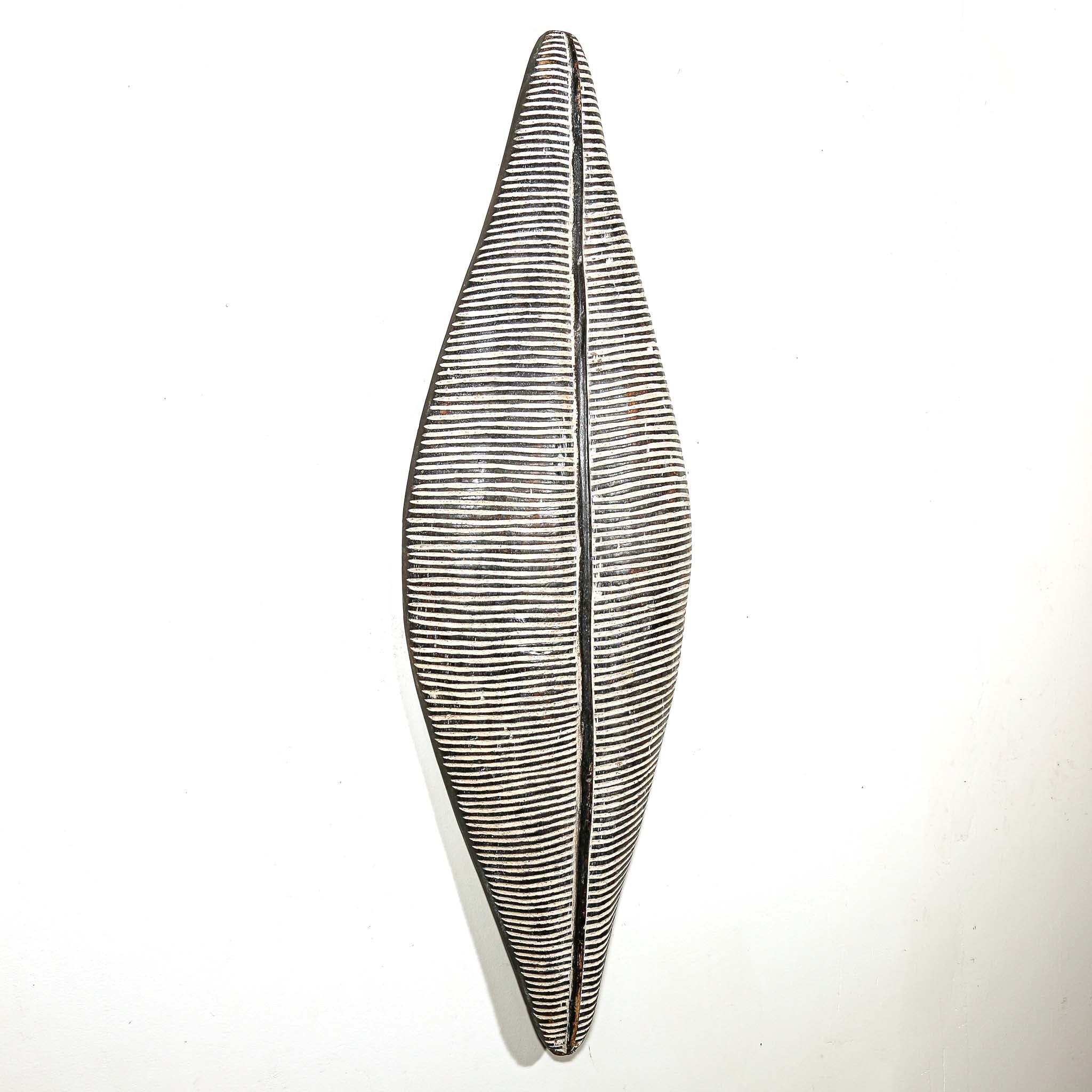 black and white wood African shield to hang on the wall for interior design ideas. Modern and tribal African art for sale.