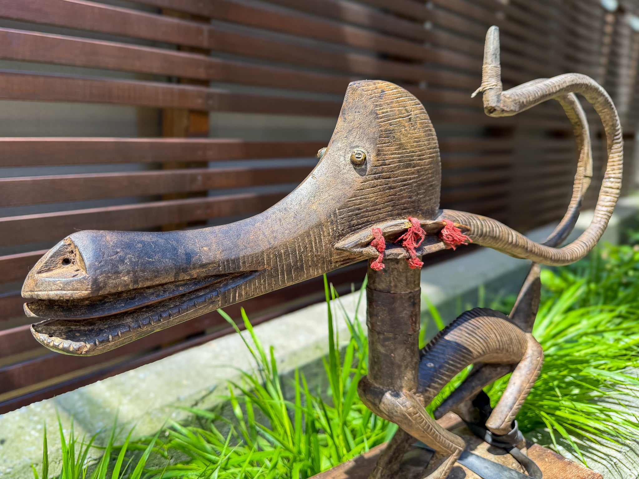 Side view of carved wooden Chiwara antelope sculpture from Mali