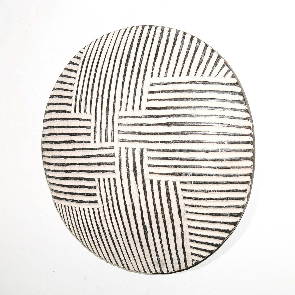 Handcrafted round Cameroon wall shield featuring a compact circular shape and distinctive African-inspired decoration