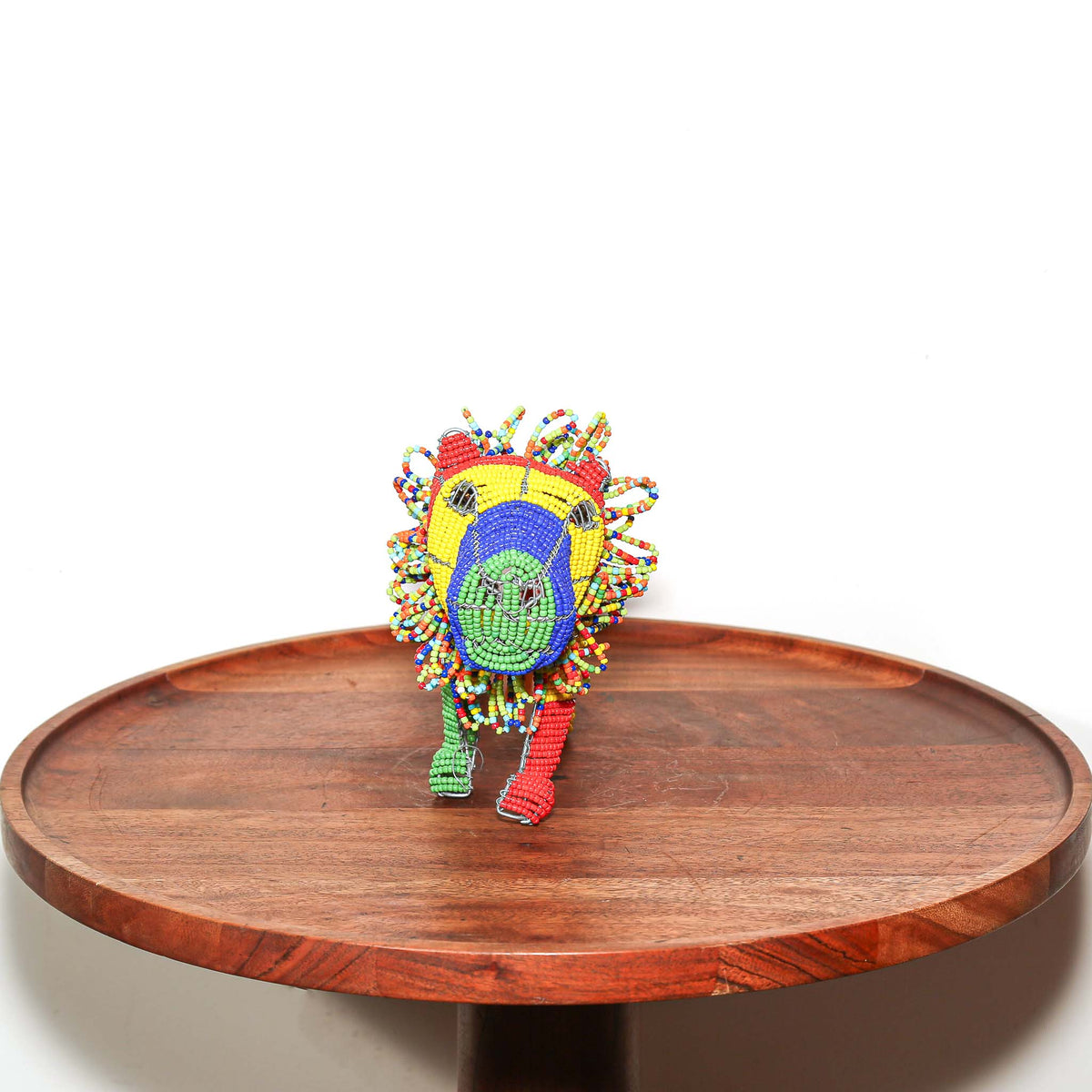 Handmade beaded lion sculpture from South Africa featuring bright colors, sculptural wirework, and expressive animal form