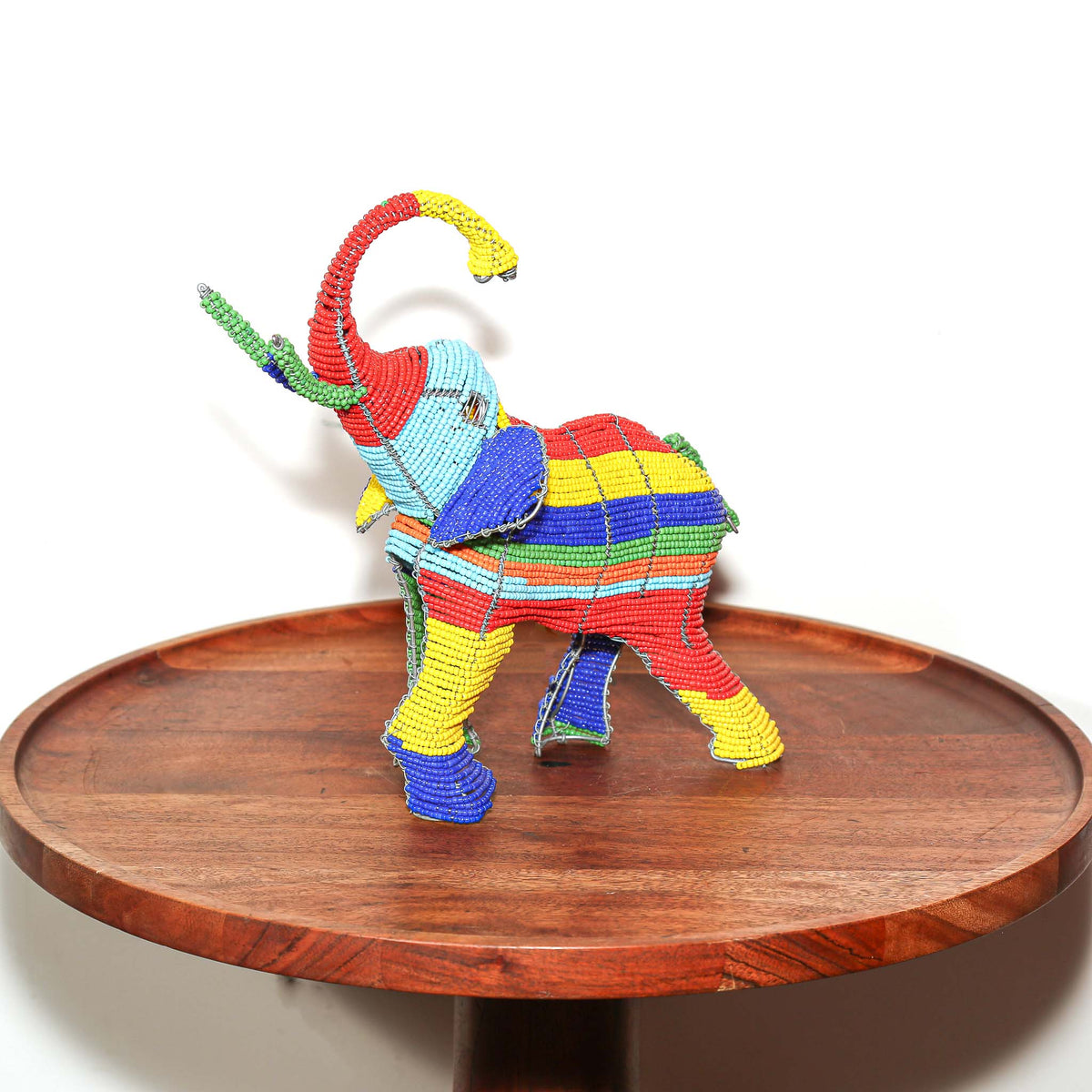 Small elephant sculpture made from wire and bright beads in South Africa, designed as decorative handmade African art