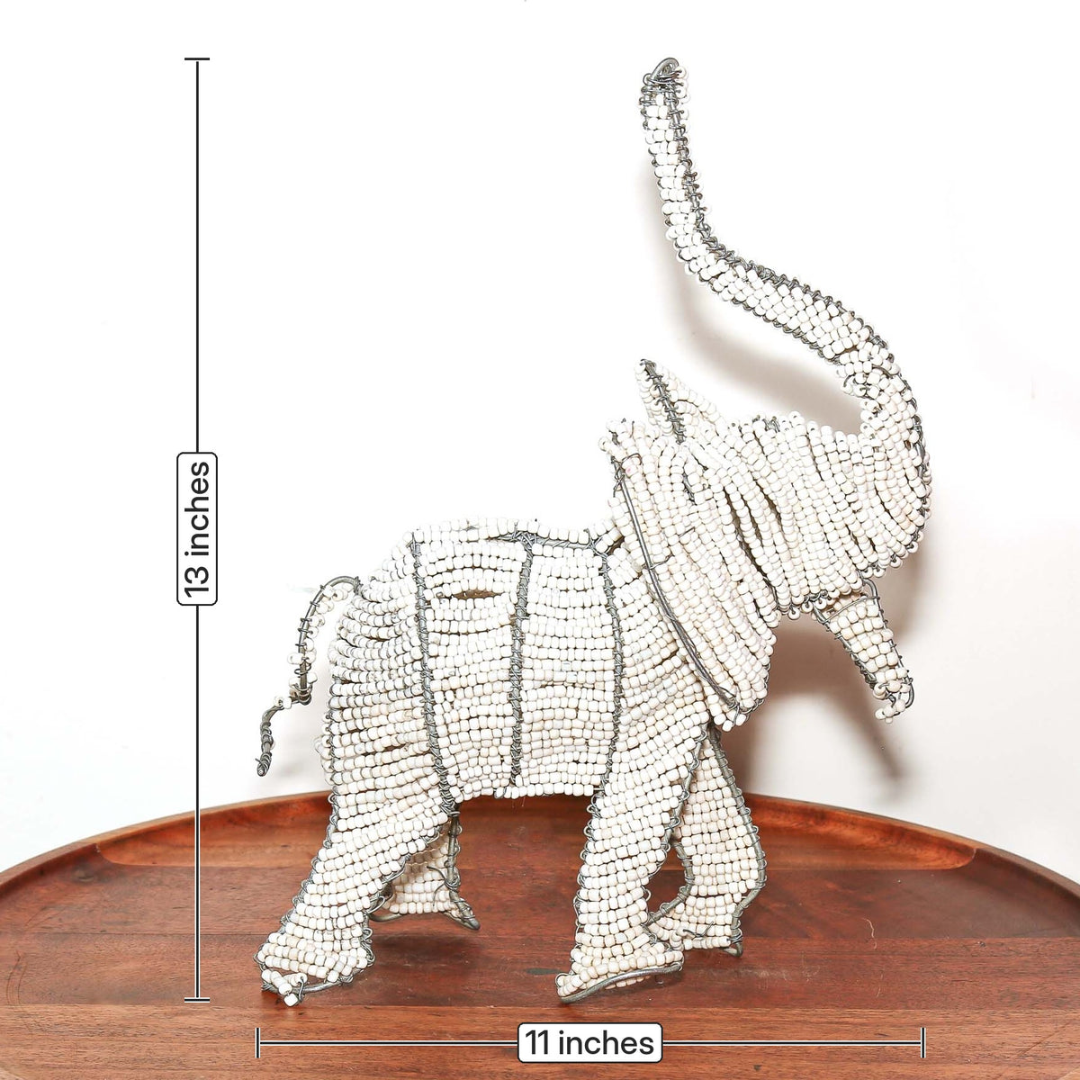Small white elephant sculpture featuring intricate beadwork and artisan wire construction from South Africa