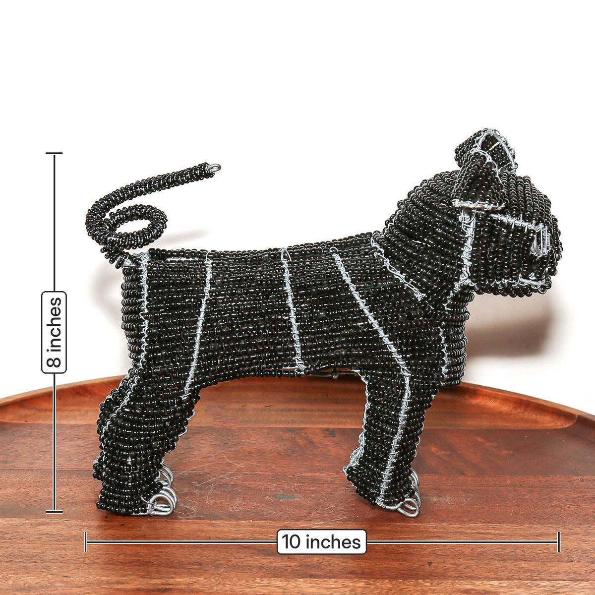 Small black beaded dog sculpture featuring a pug design, handmade wire construction, and collectible African craftsmanship
