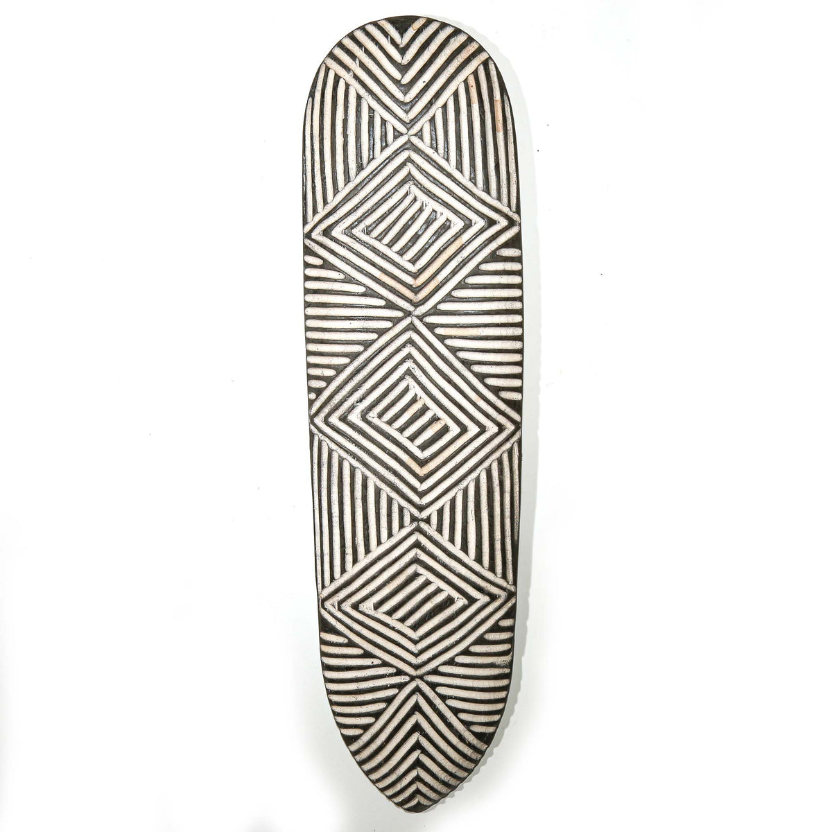 Long black and white decorative shield from Cameroon with refined craftsmanship and bold geometric surface patterning