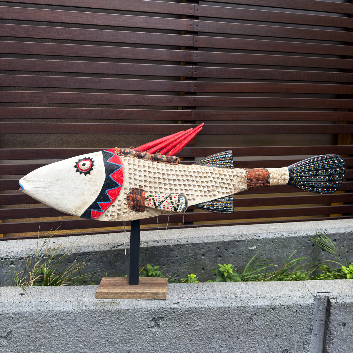 Large white fish sculpture puppet with hand-carved details, articulated form, and strong decorative presence