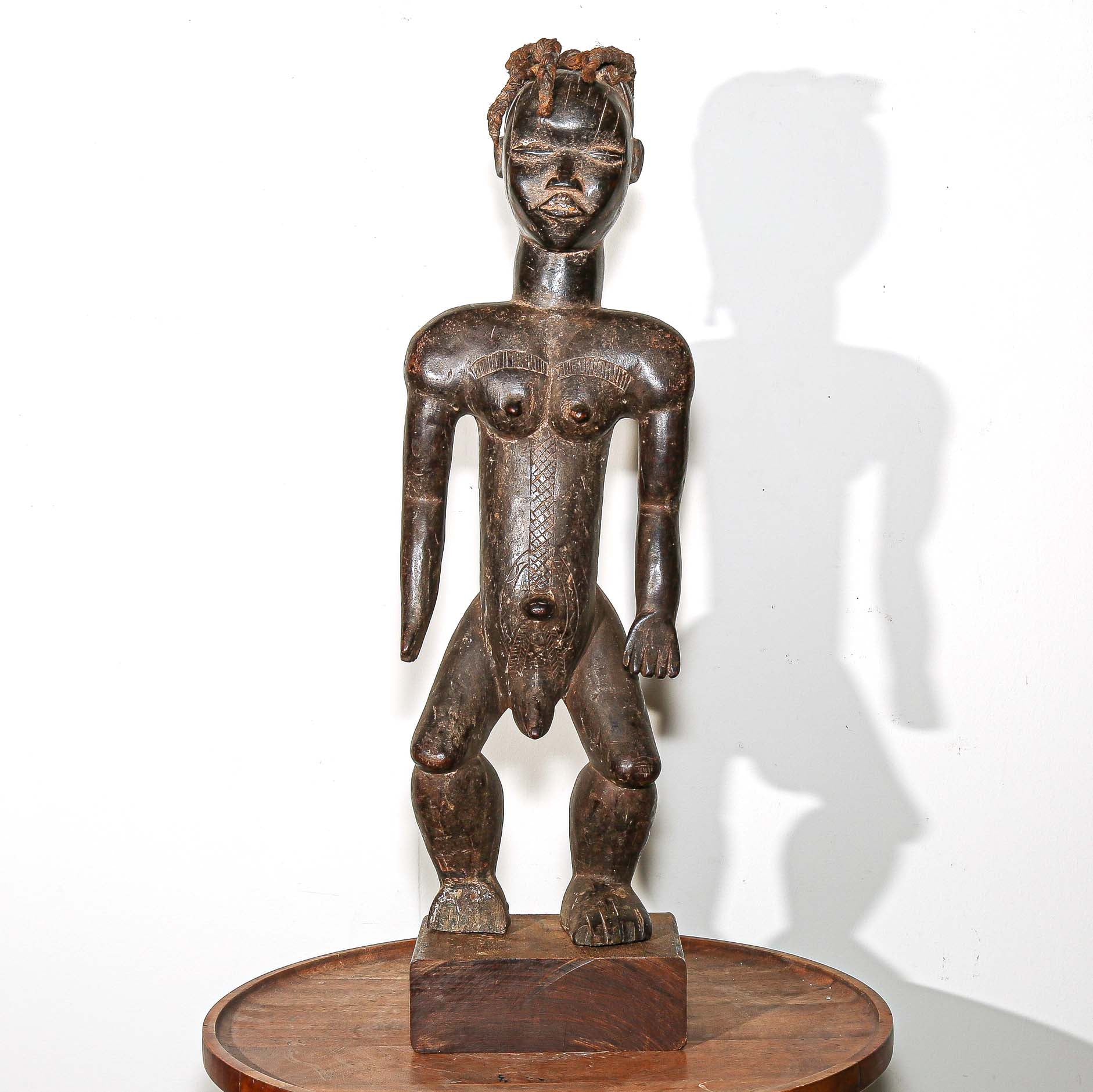 wooden male figure sculpture carved by the Dan people in Ivory Coast 