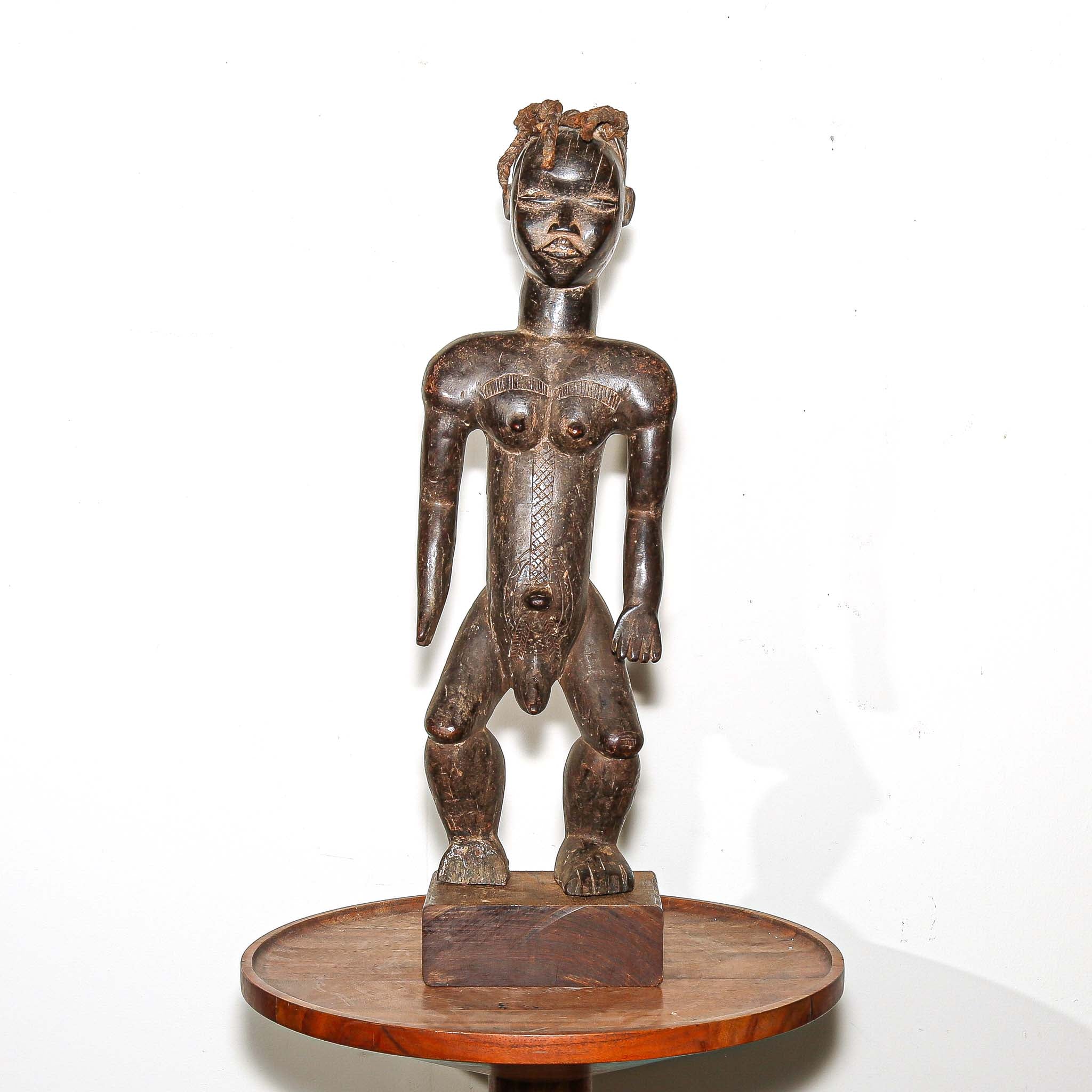wooden male figure sculpture carved by the Dan people in Ivory Coast 