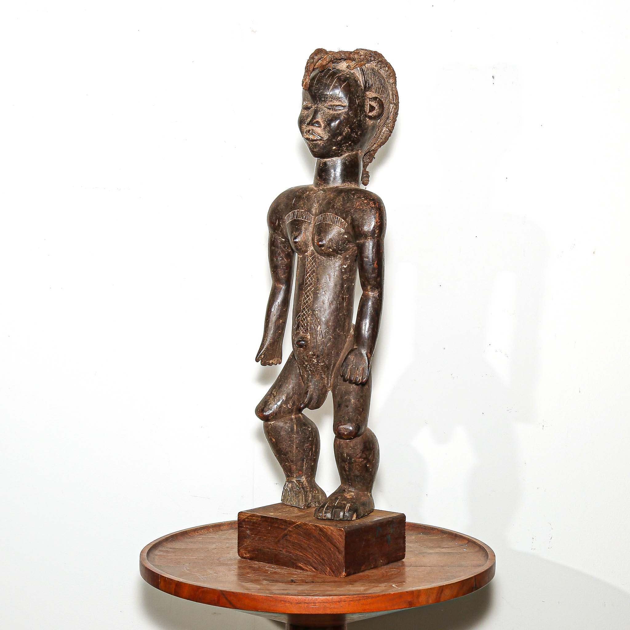 wooden male figure sculpture carved by the Dan people in Ivory Coast 