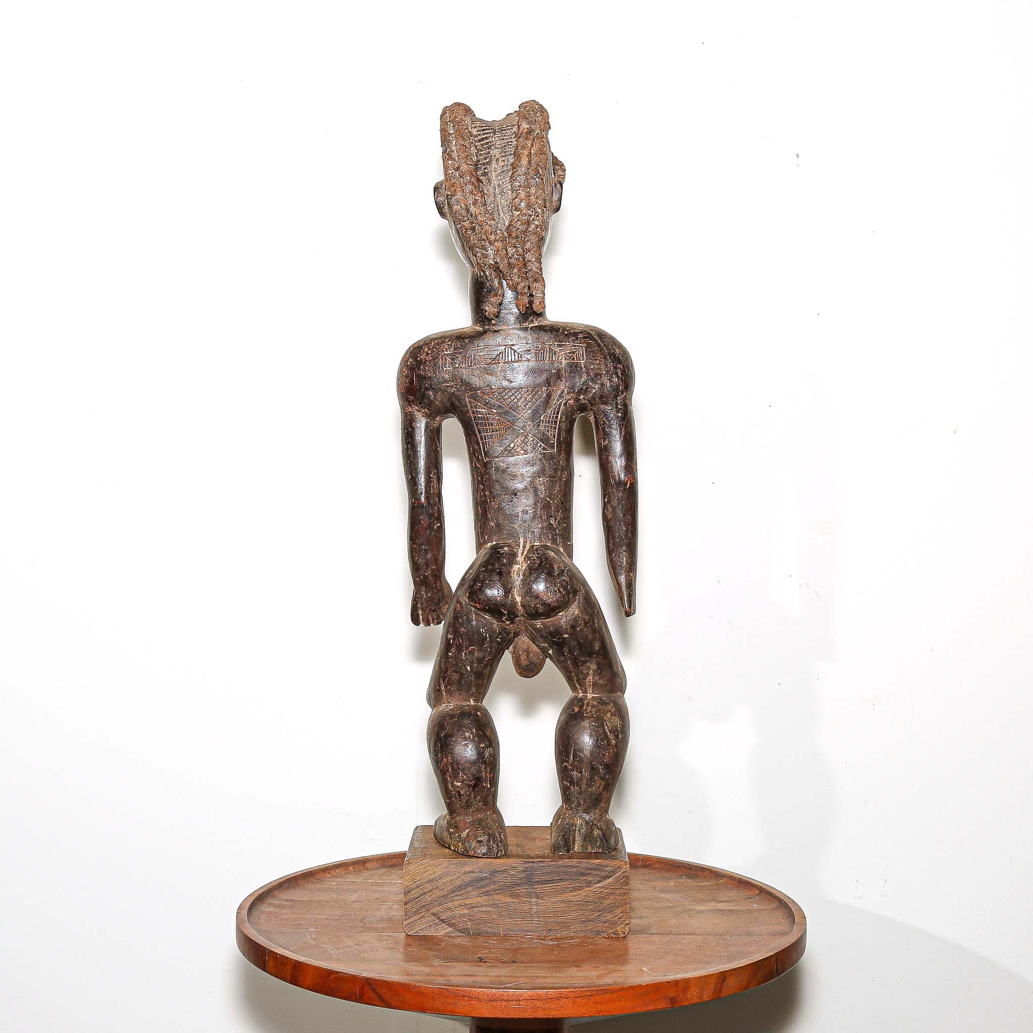 wooden male figure sculpture carved by the Dan people in Ivory Coast 