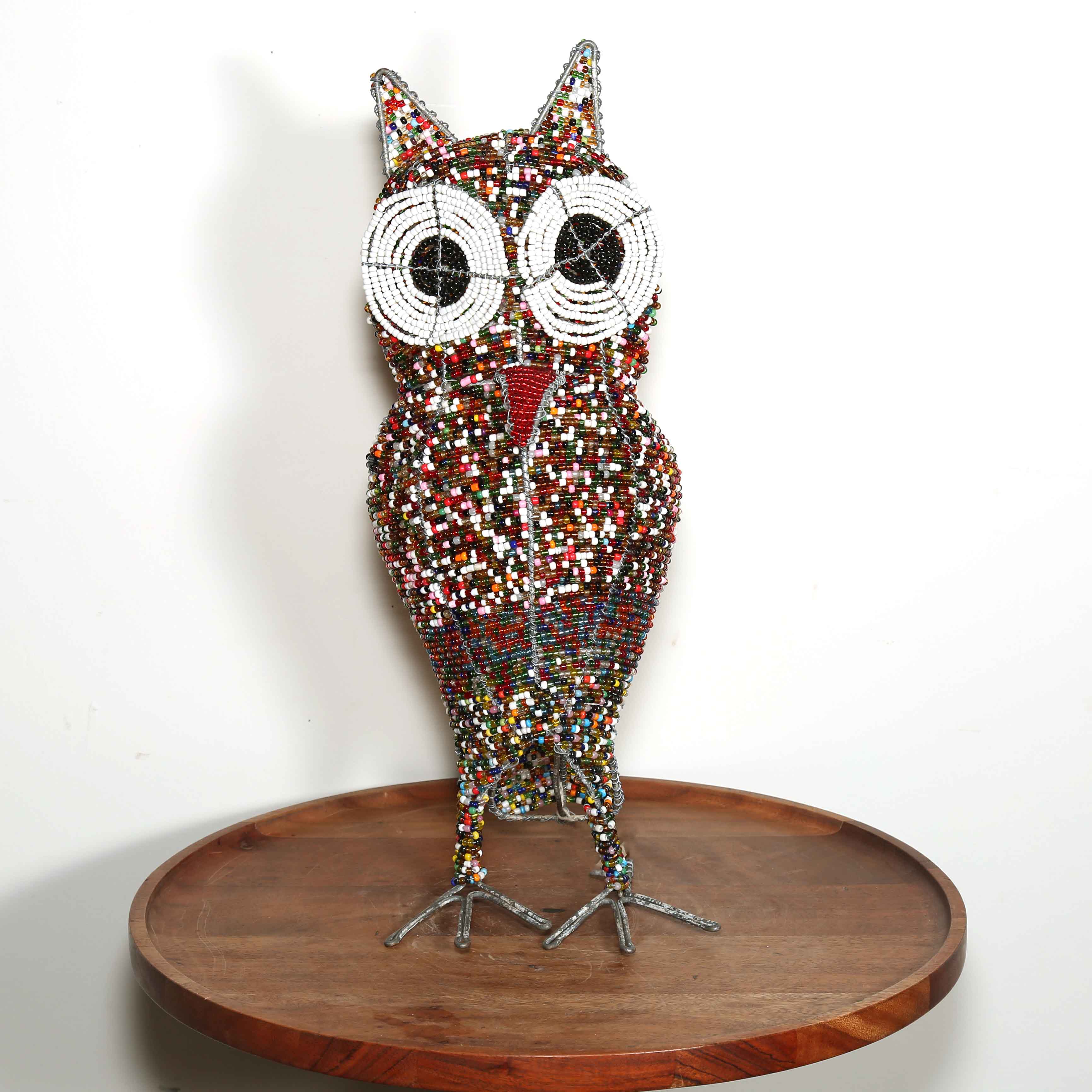 owl art made from beads on a table