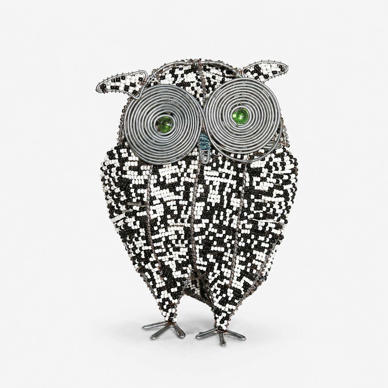 Decorative owl sculpture with black and white pattern on a white background