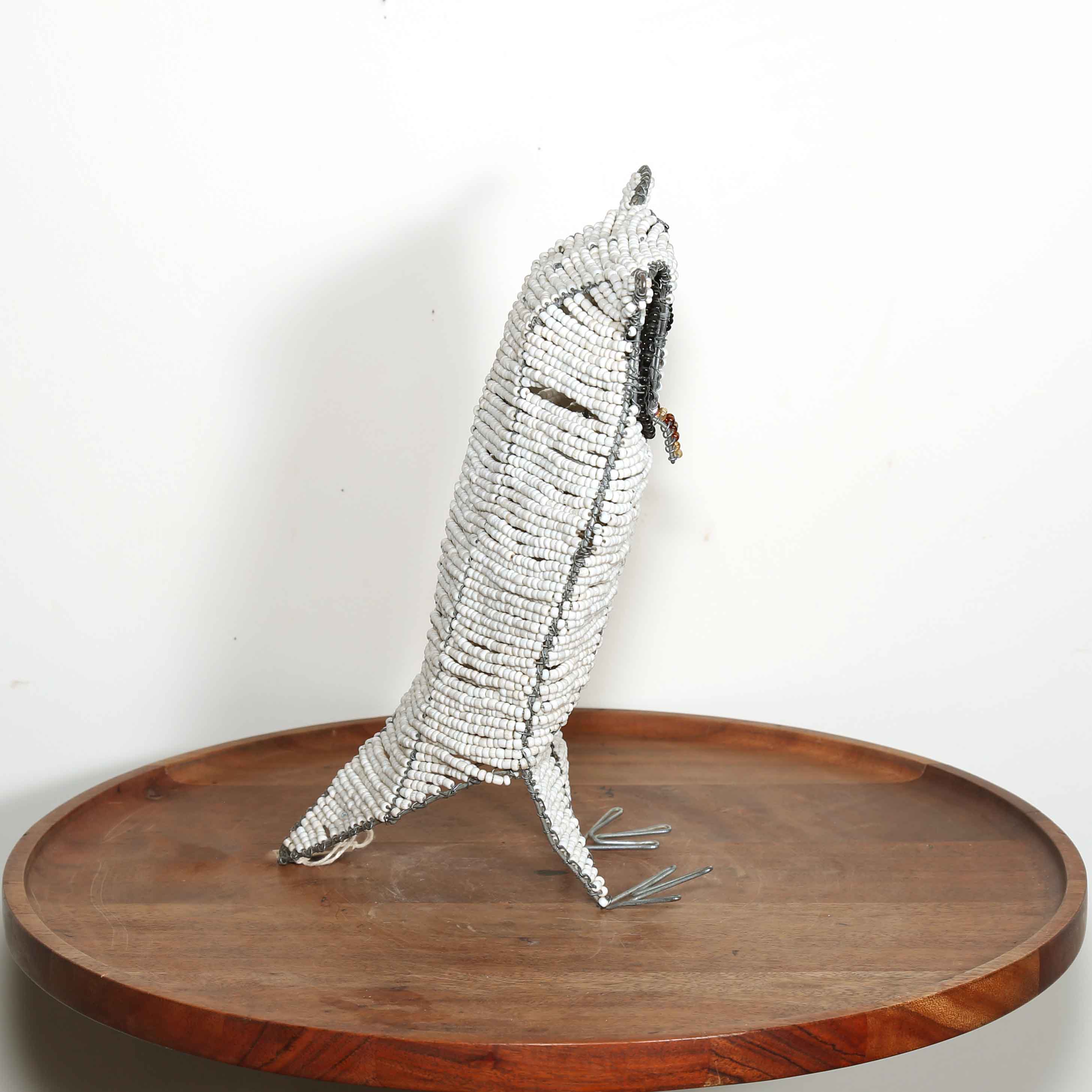 little white owl sculpture from Africa made from glass beads shown from the side