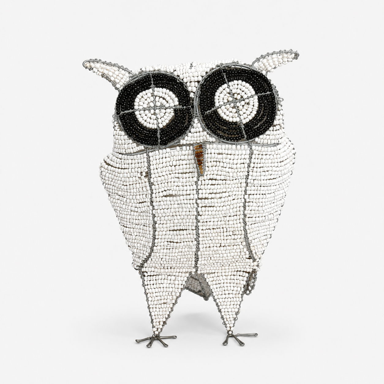 Decorative owl sculpture made of beaded material on a white background