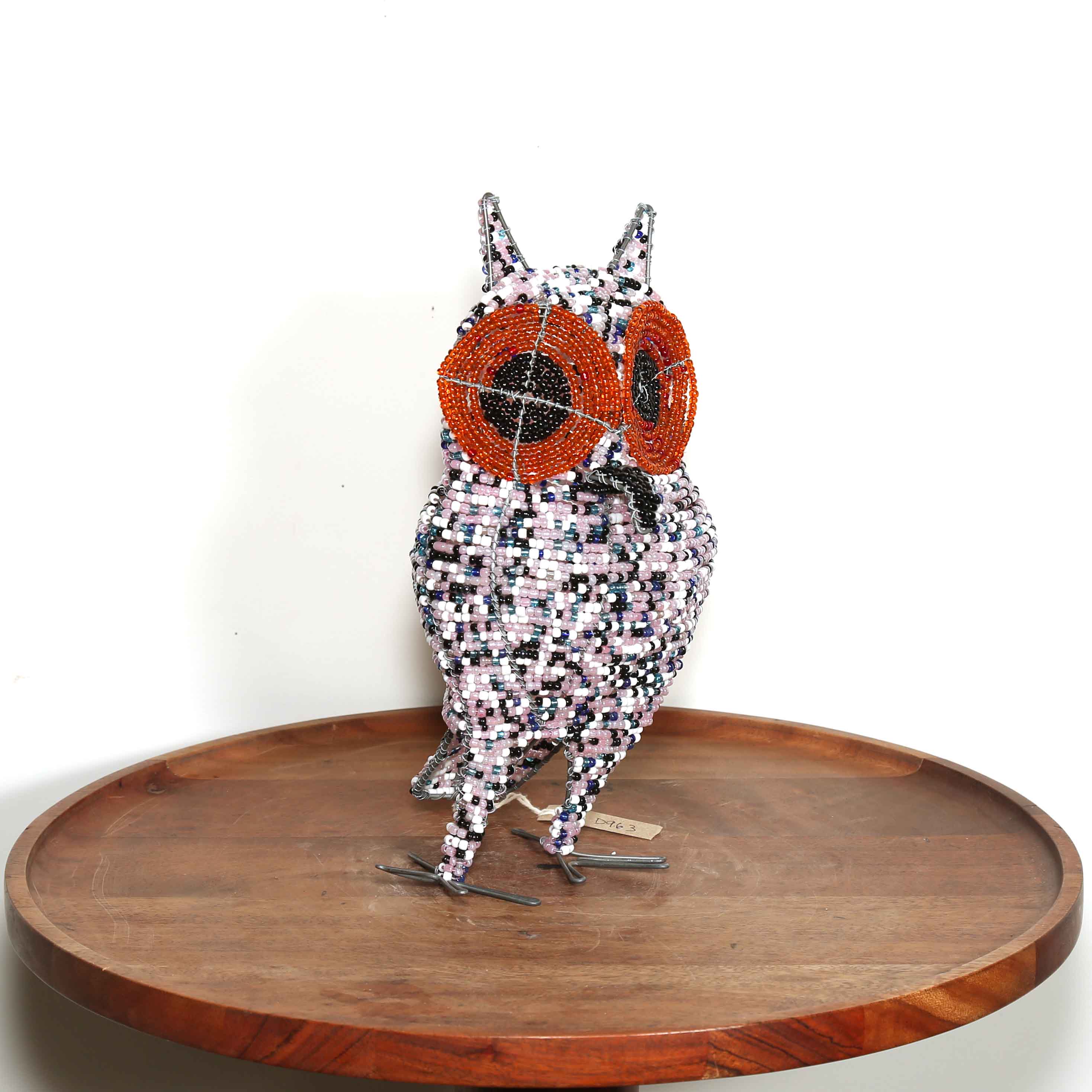 speckled pink African owl artwork with black and orange eyes handmade in Africa