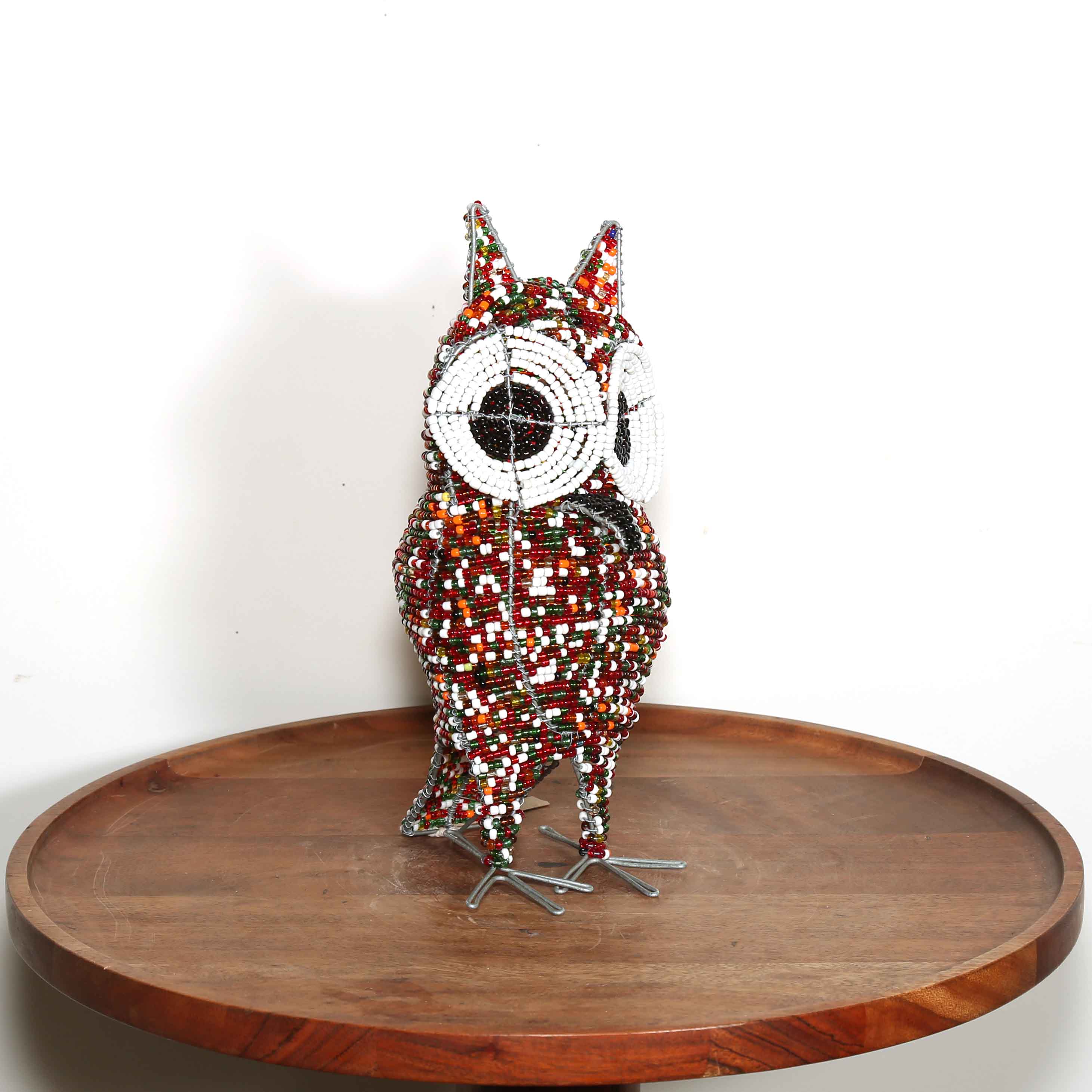 small colorful hand made art from South Africa in the shape of an owl
