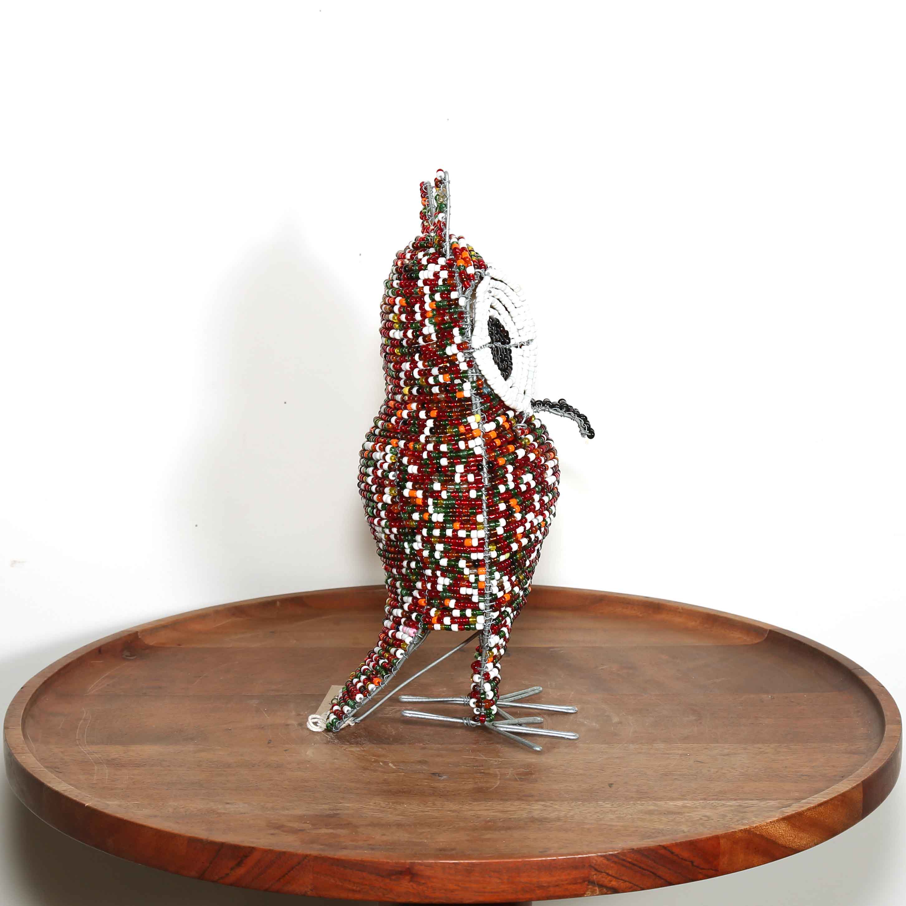 small colorful hand made art from South Africa in the shape of a bird