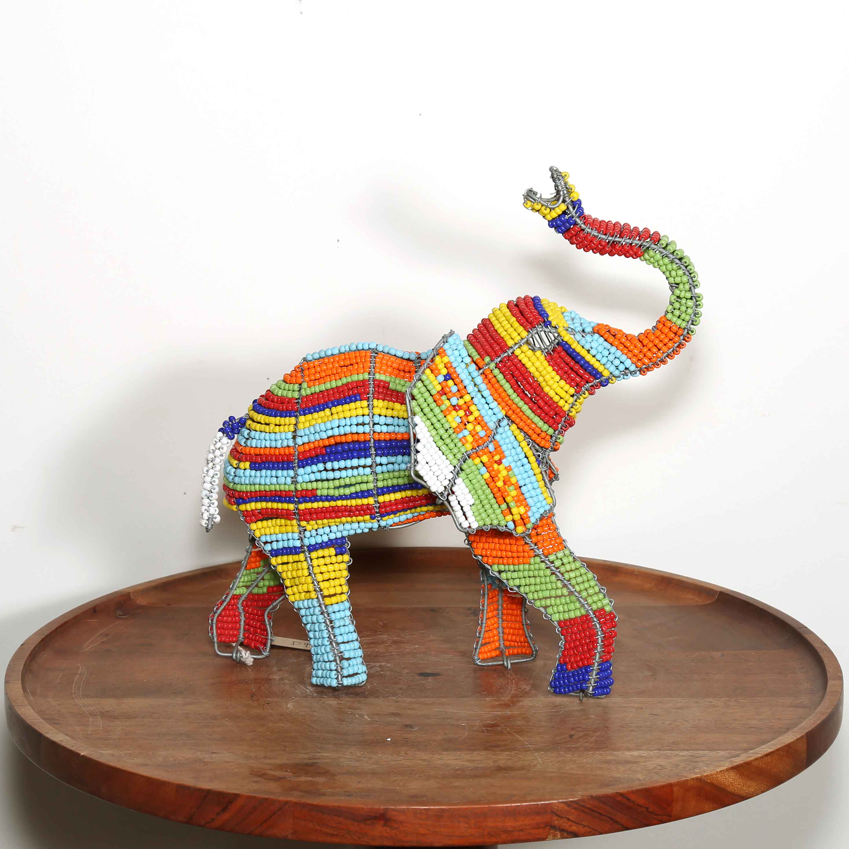 Rainbow colored beaded sculpture of an elephant from Africa